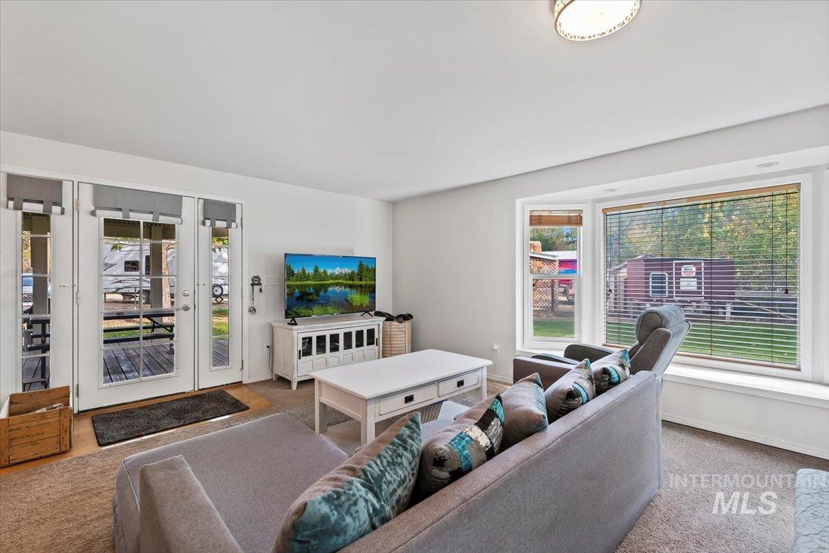 Carpeted living room featuring baseboards