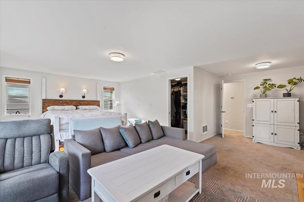 Bedroom with carpet and a spacious closet