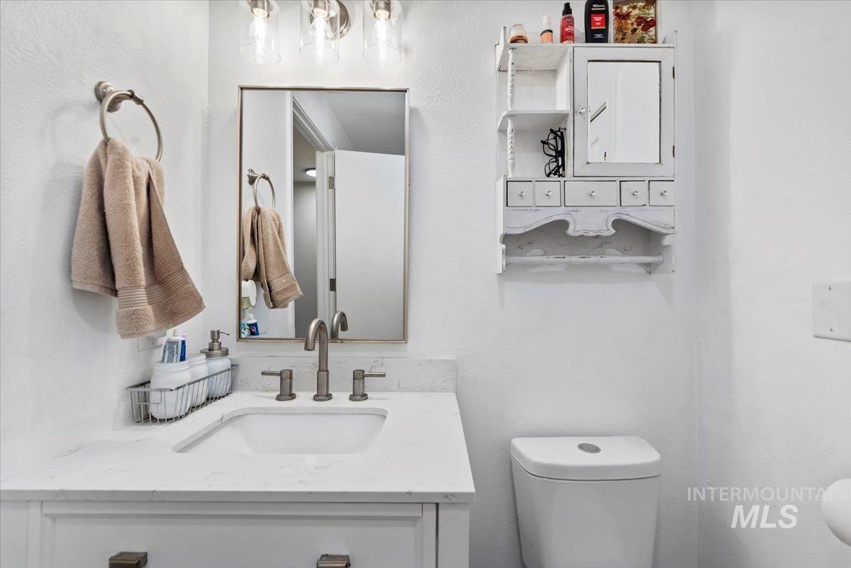 Bathroom featuring vanity and a textured wall