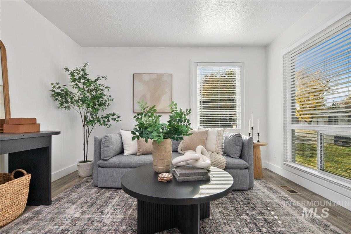 Sitting room featuring wood finished floors and a textured ceiling