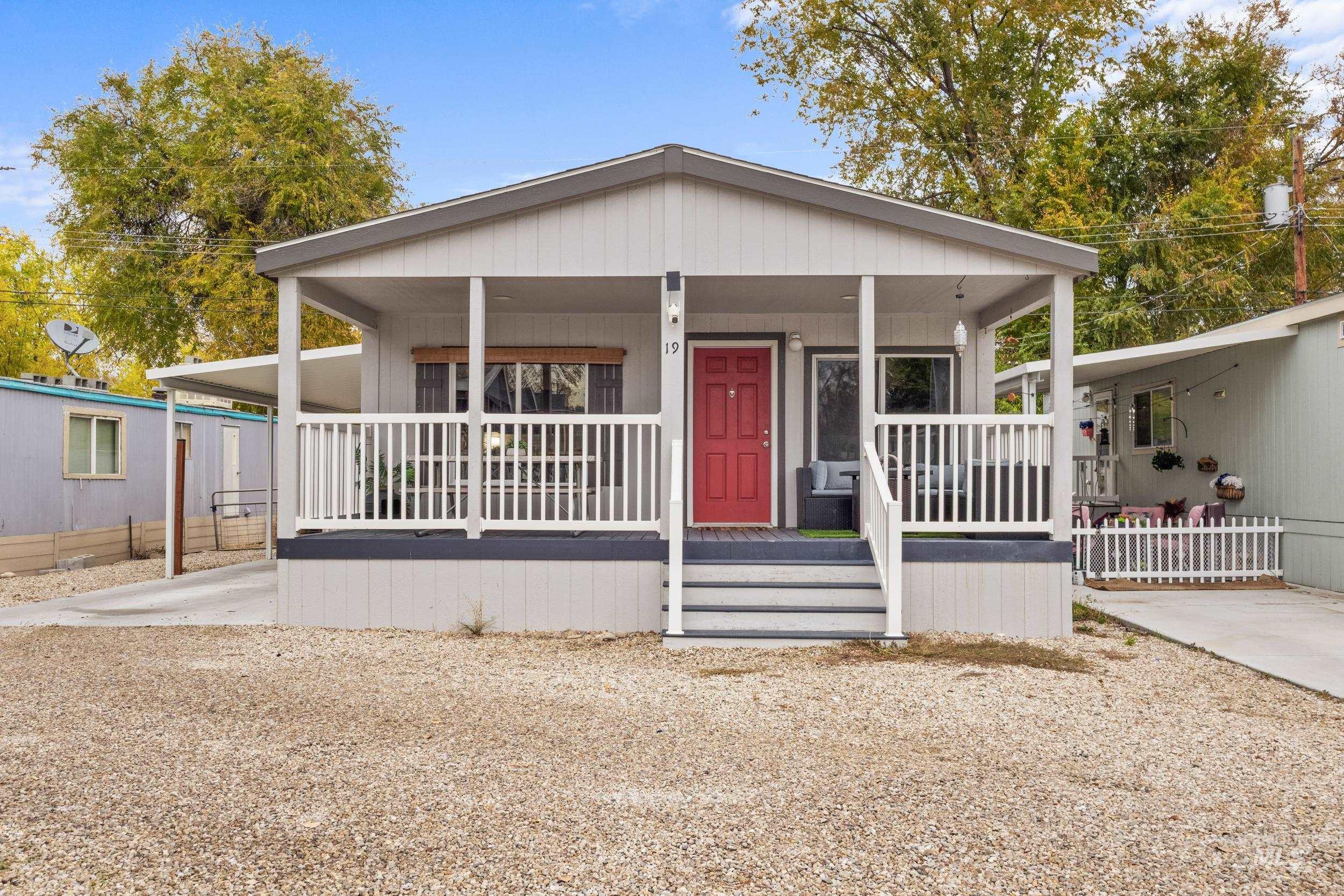 Manufactured / mobile home with a porch and an attached carport