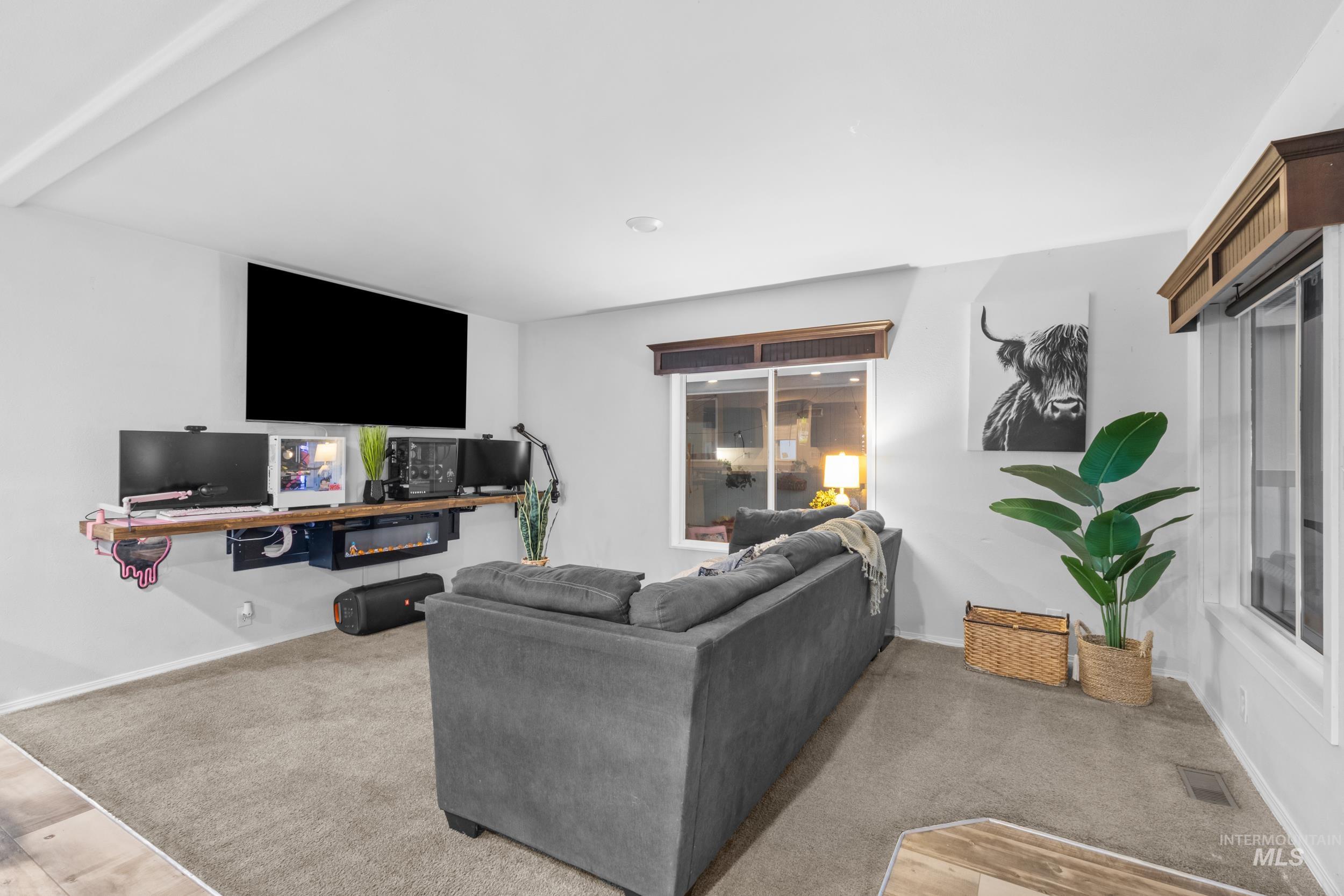Living area with carpet floors and baseboards