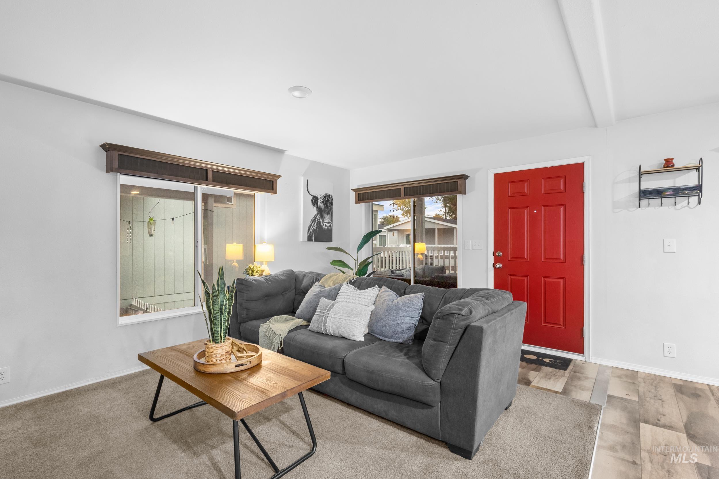 Living area featuring beamed ceiling and light wood-style floors