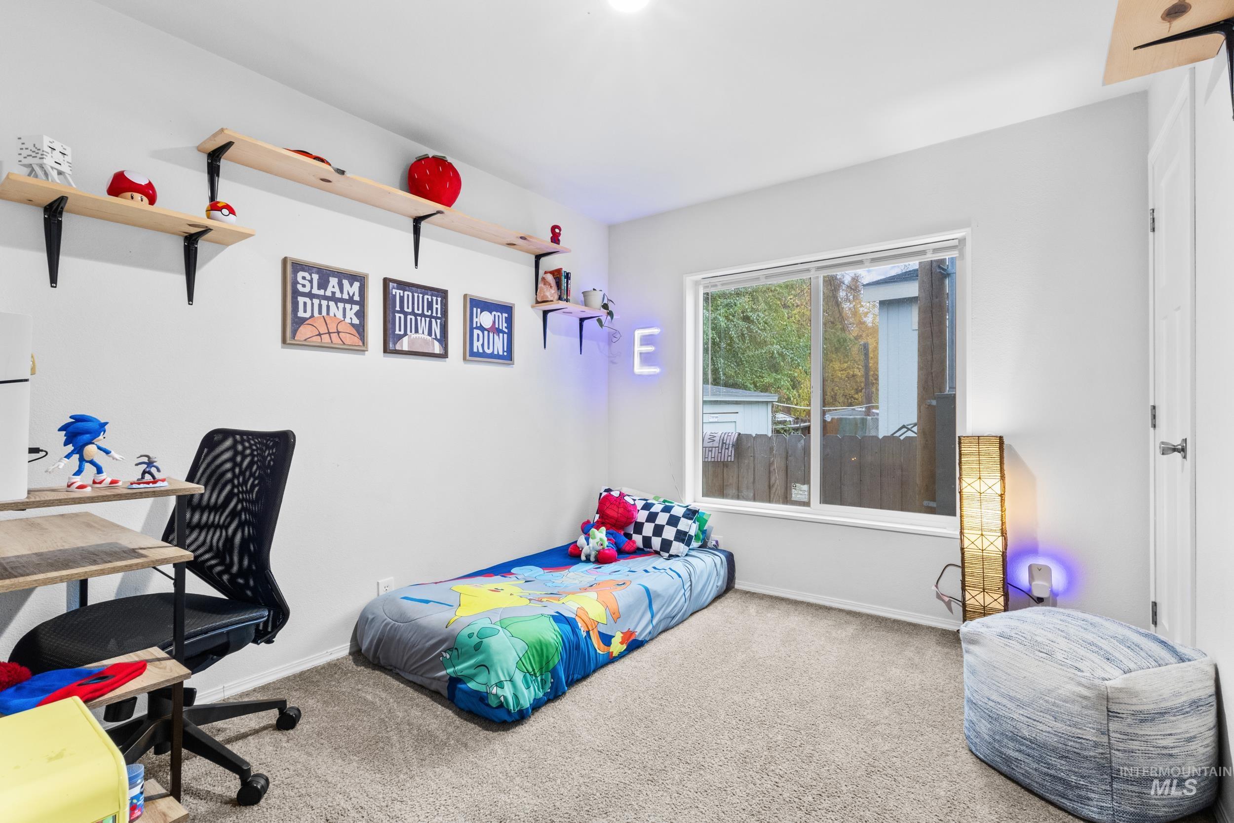 Bedroom with carpet floors and a desk