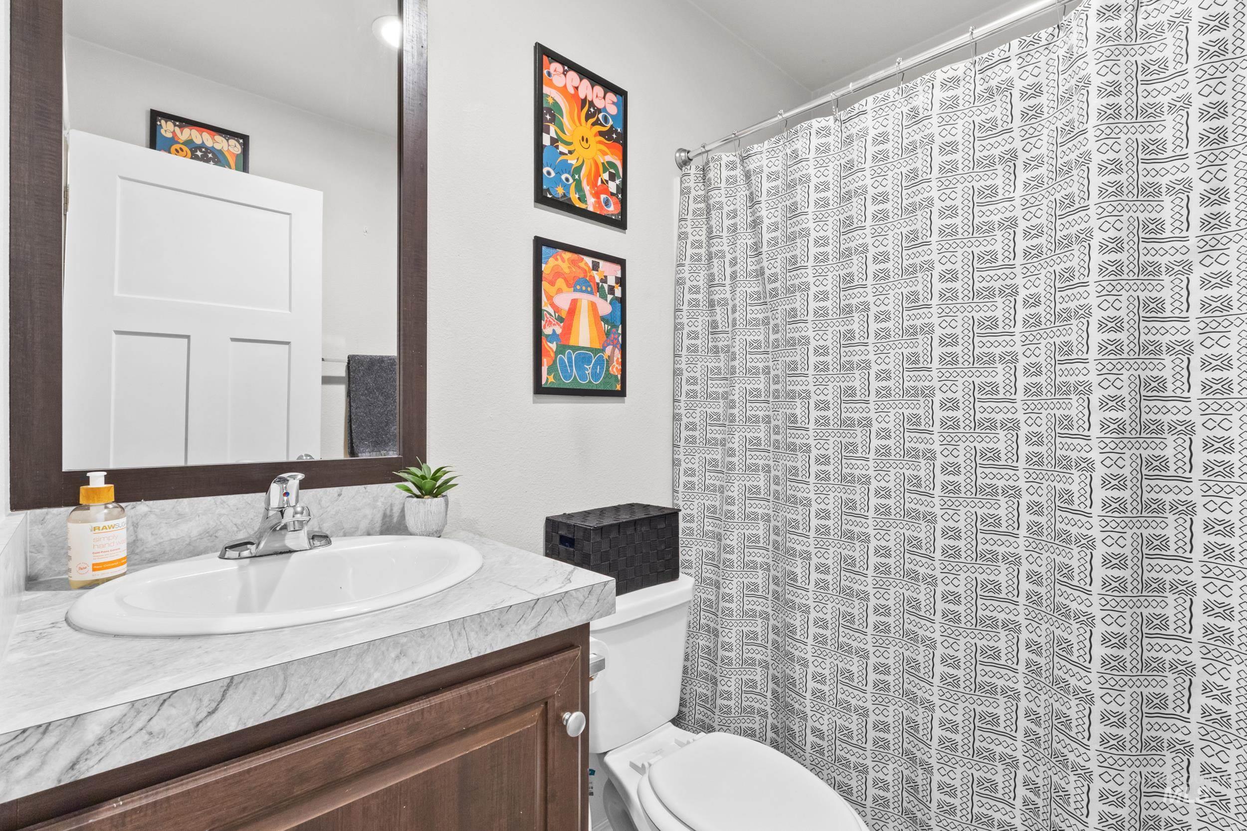 Bathroom featuring vanity and a shower with shower curtain