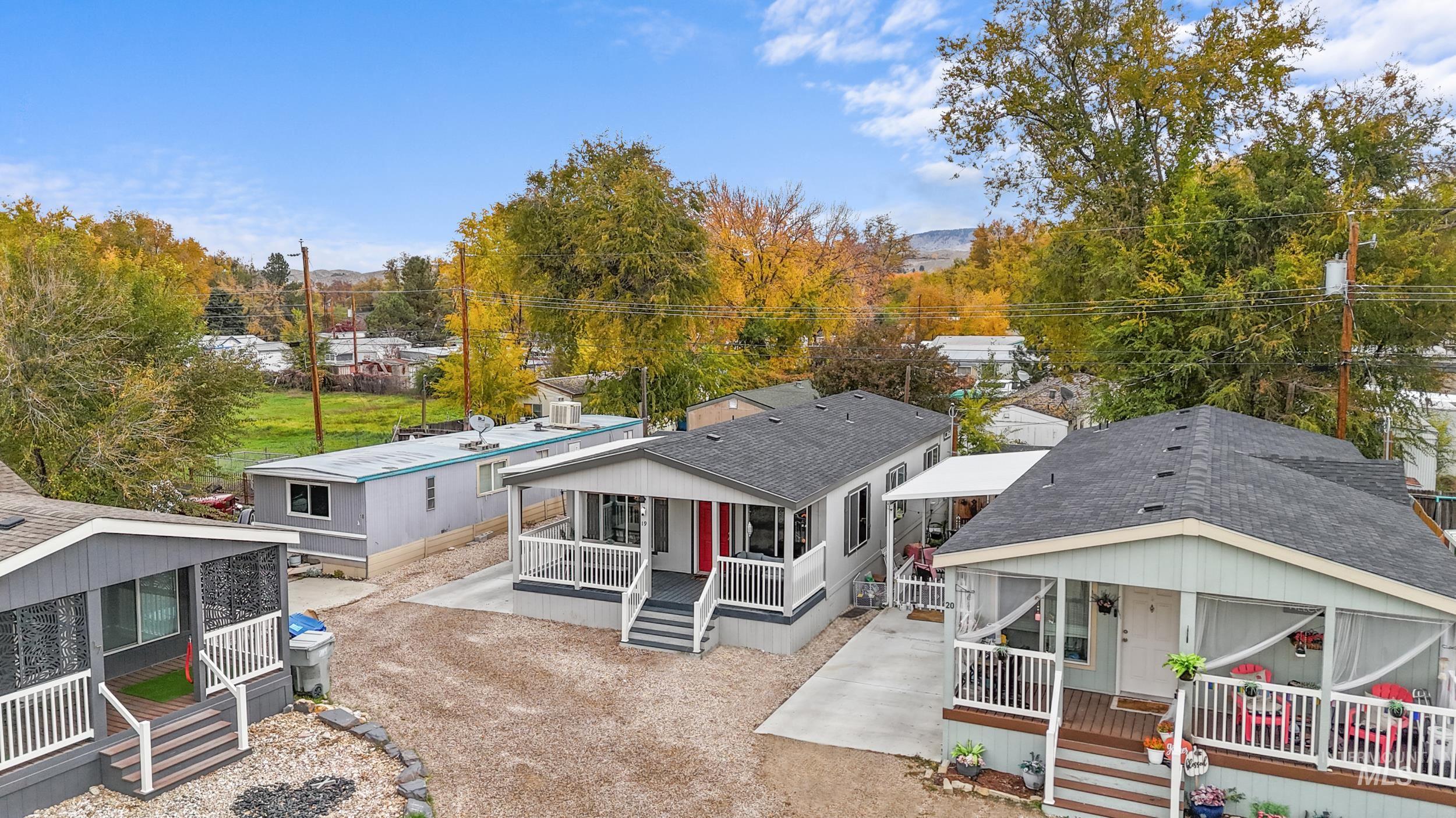 Rear view of property with a shingled roof and a wooden deck