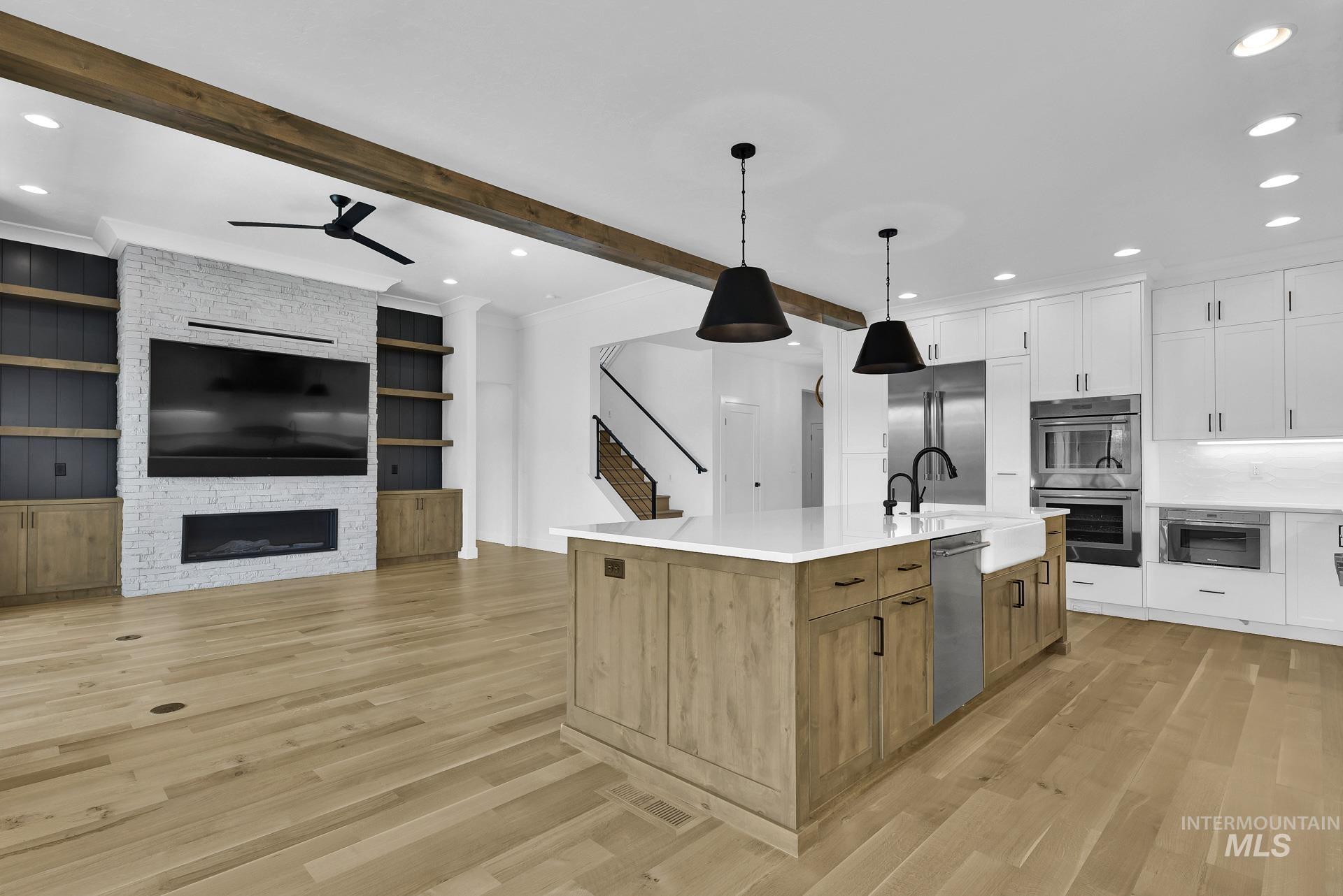 Kitchen featuring a ceiling fan, stainless steel appliances, recessed lighting, light wood-style floors, and light countertops