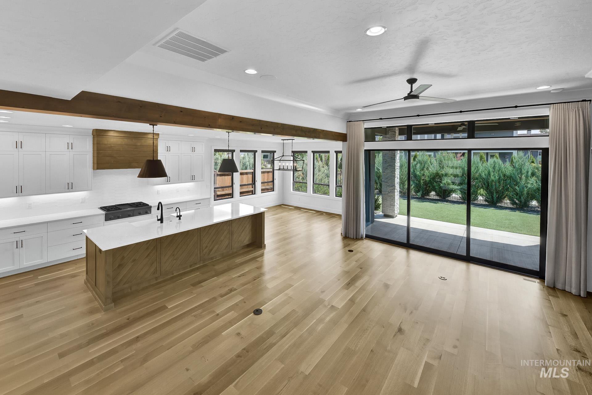 Unfurnished living room featuring a ceiling fan, recessed lighting, and light wood finished floors