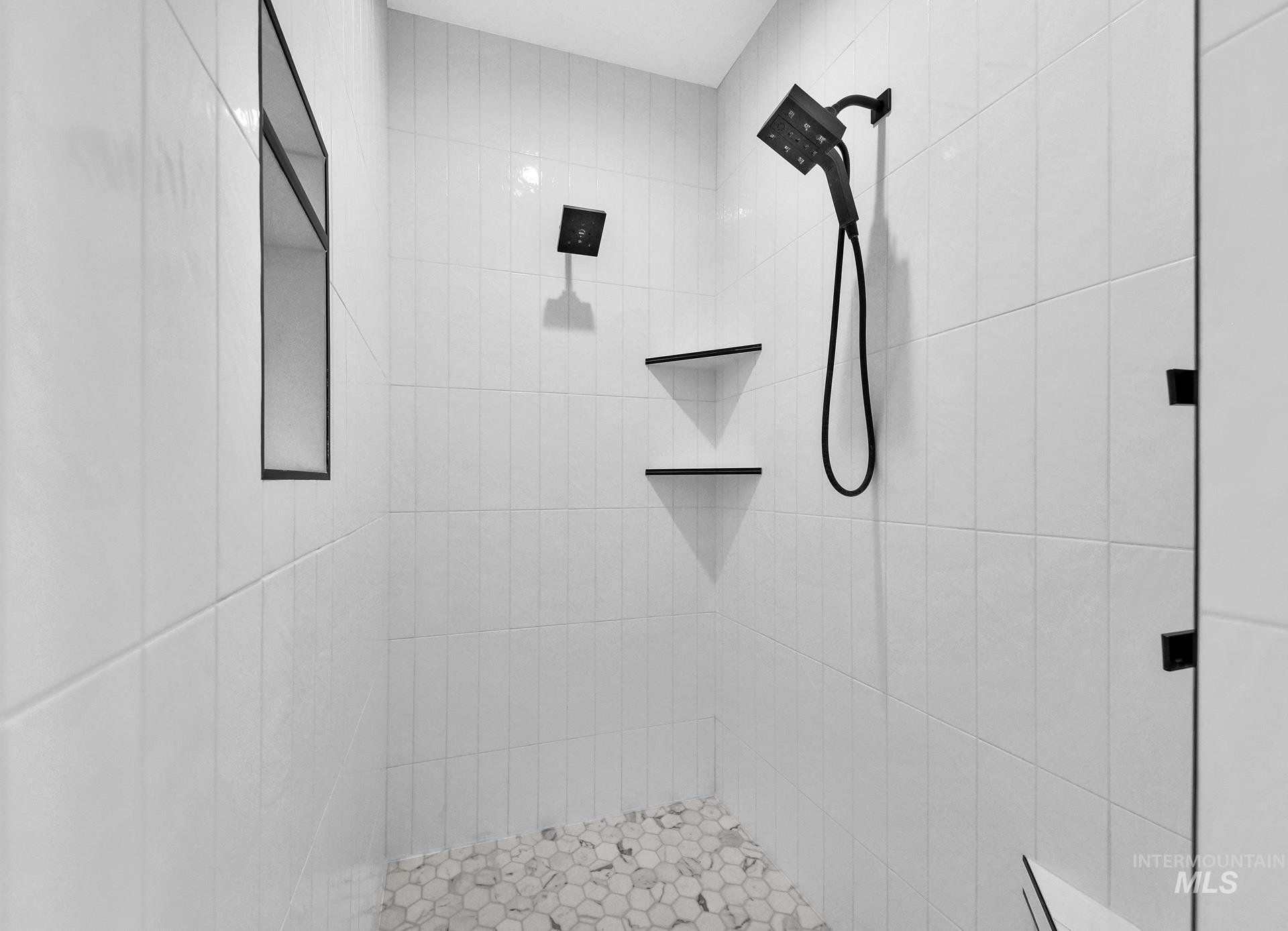 Full bath featuring tiled shower