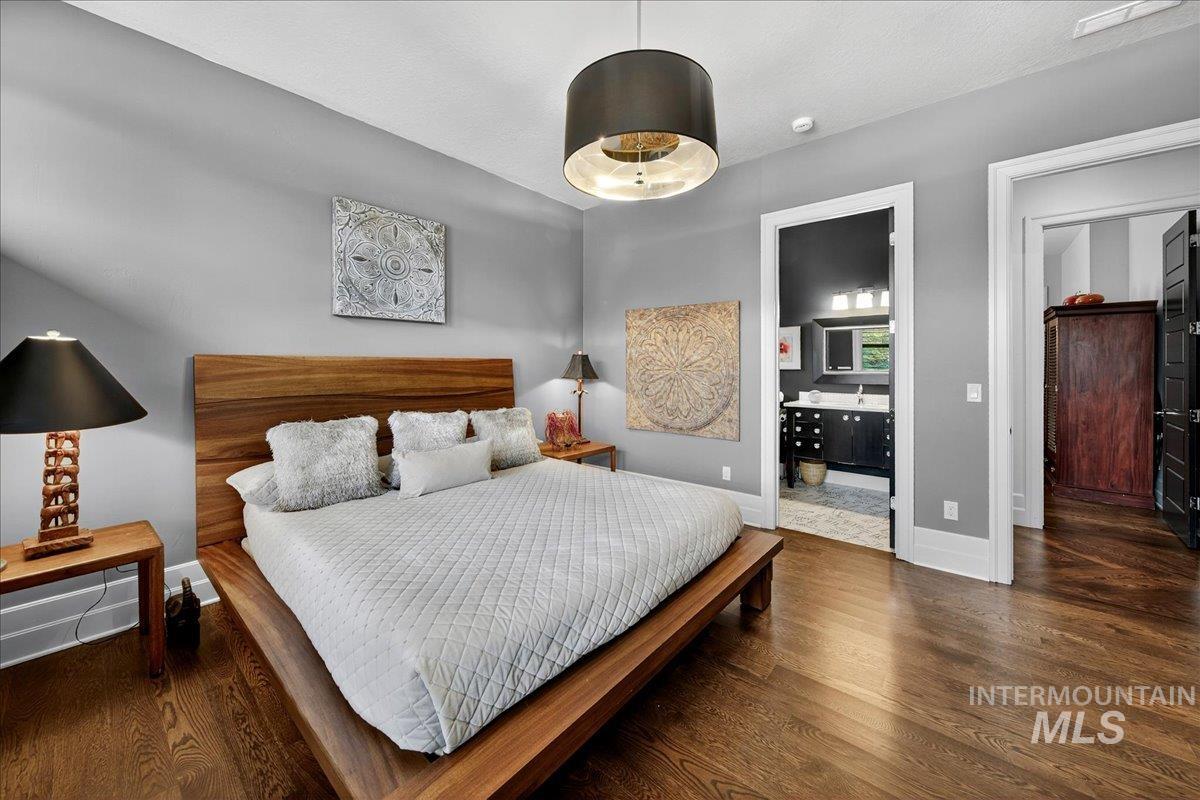 Bedroom featuring ensuite bath and wood finished floors