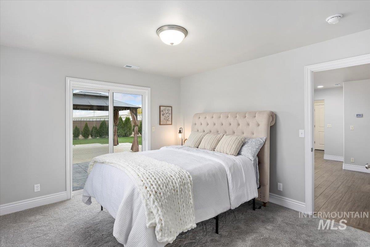 Bedroom with access to exterior and carpet