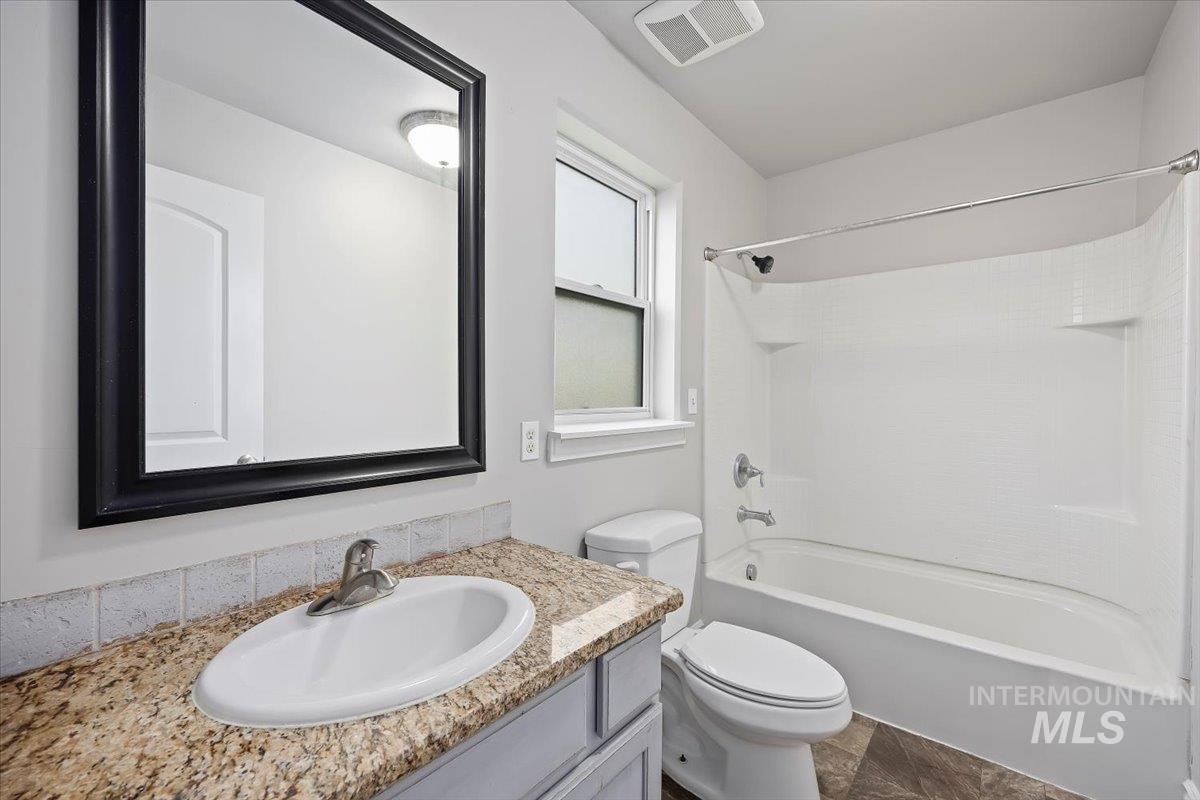 Full bathroom featuring washtub / shower combination and vanity