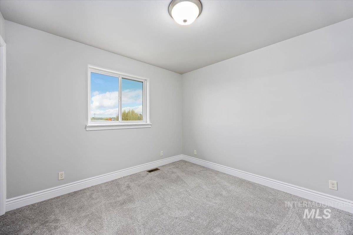 Spare room with carpet flooring and baseboards