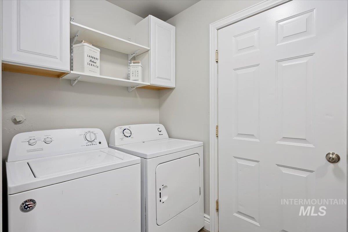 Laundry area featuring washer and dryer and cabinet space