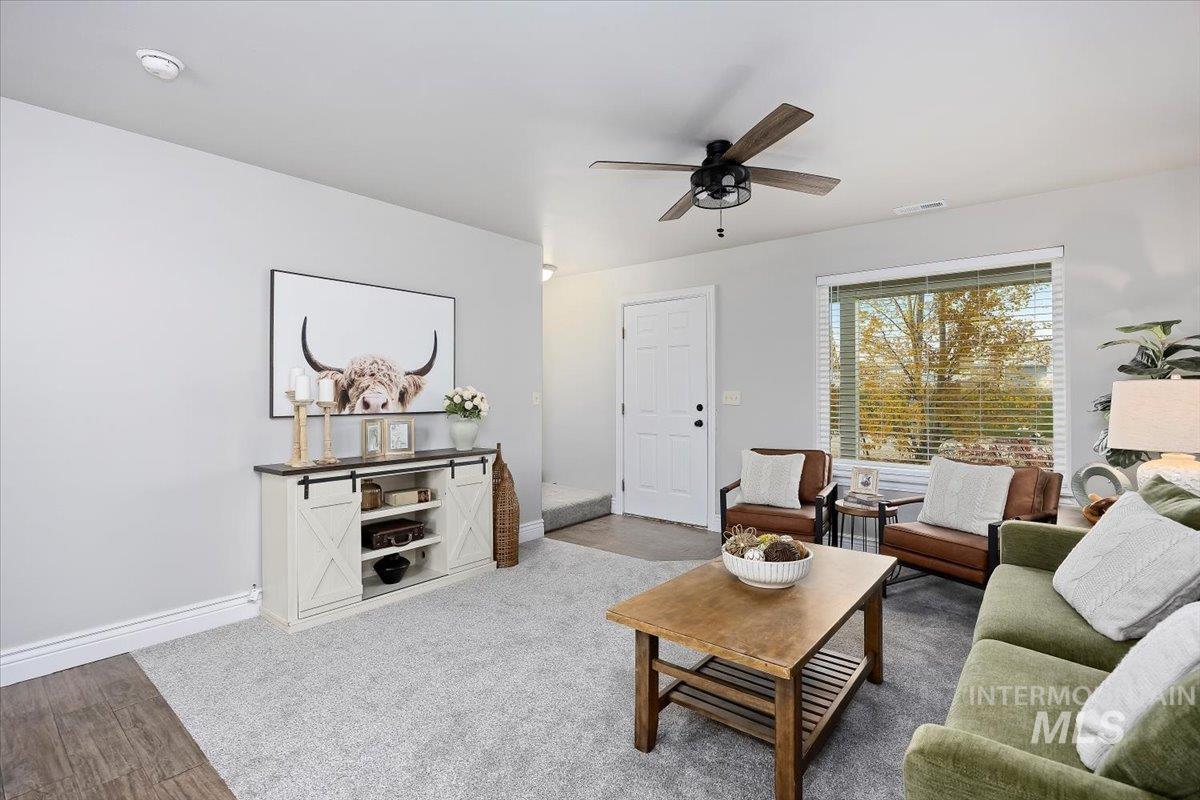 Living area featuring wood finished floors and ceiling fan