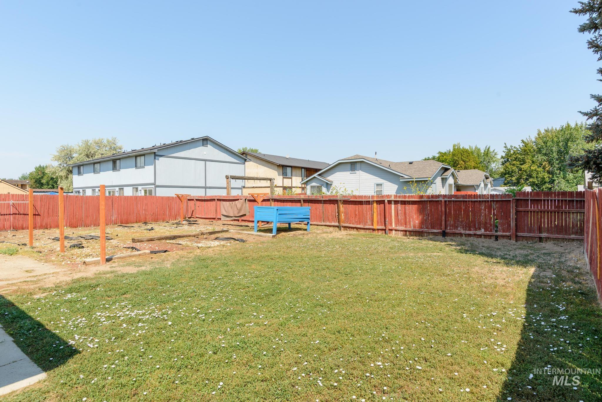 Fenced backyard with a residential view