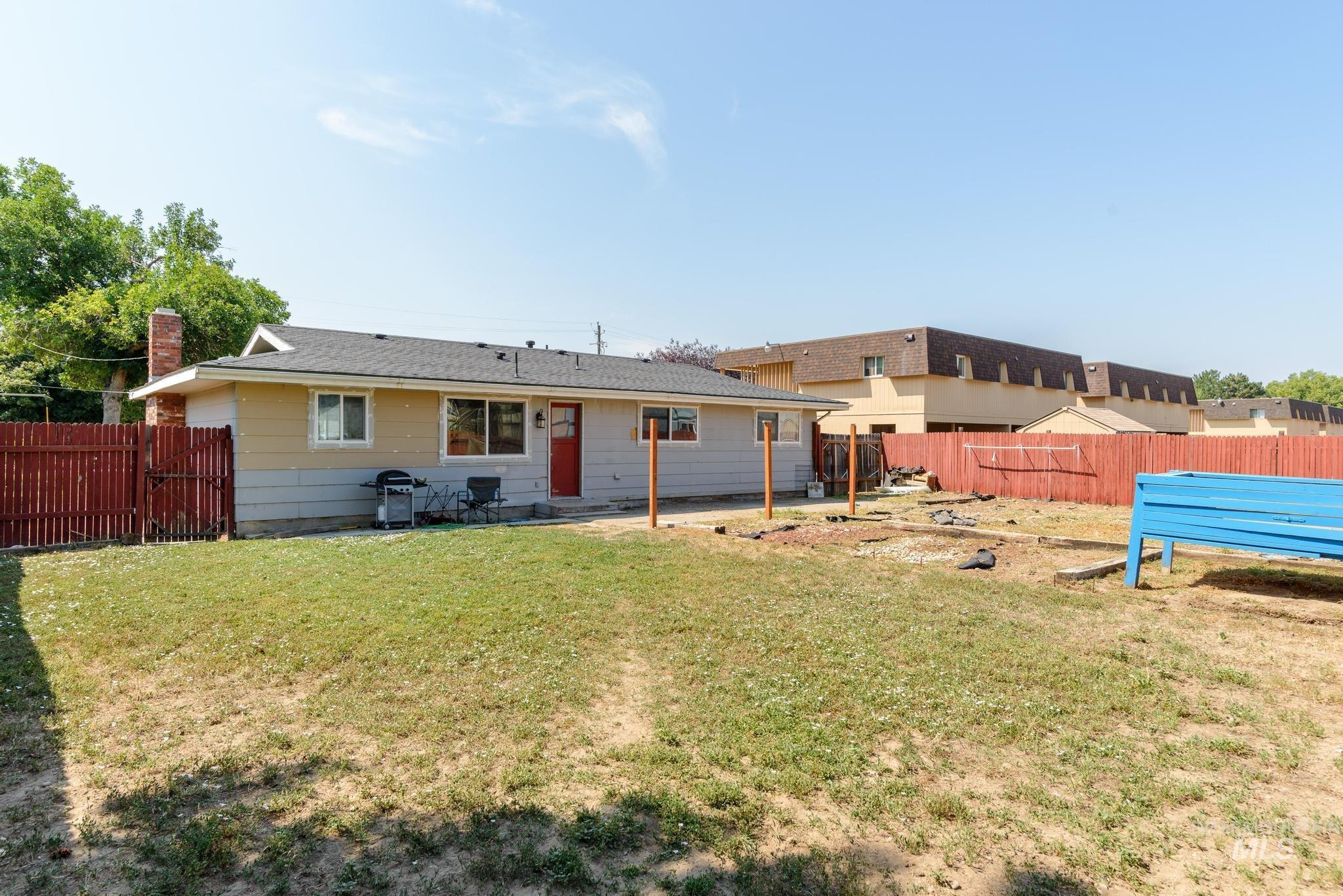 Rear view of property with a fenced backyard and a patio area