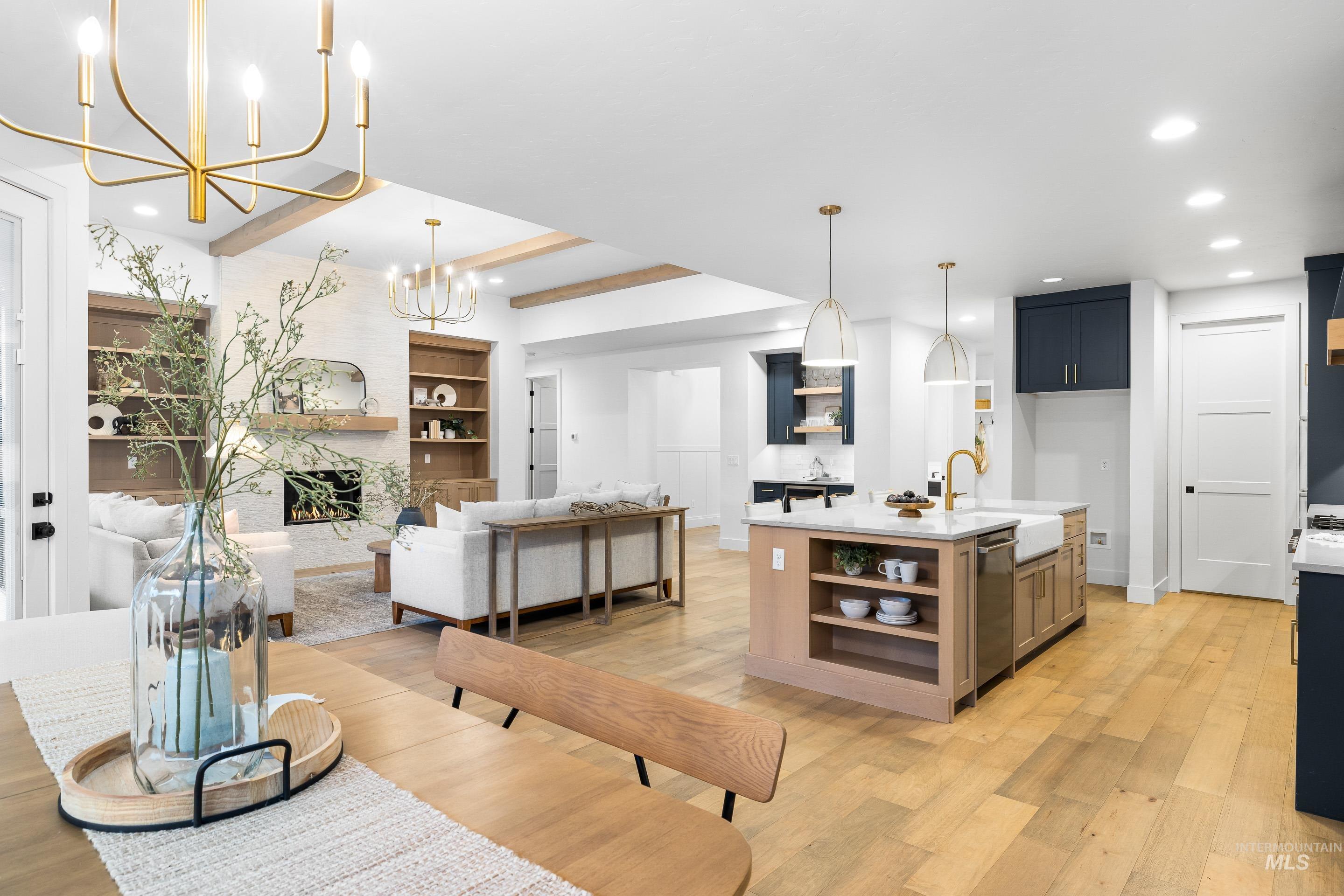 Dining space with beamed ceiling, light wood-style flooring, recessed lighting, and a chandelier