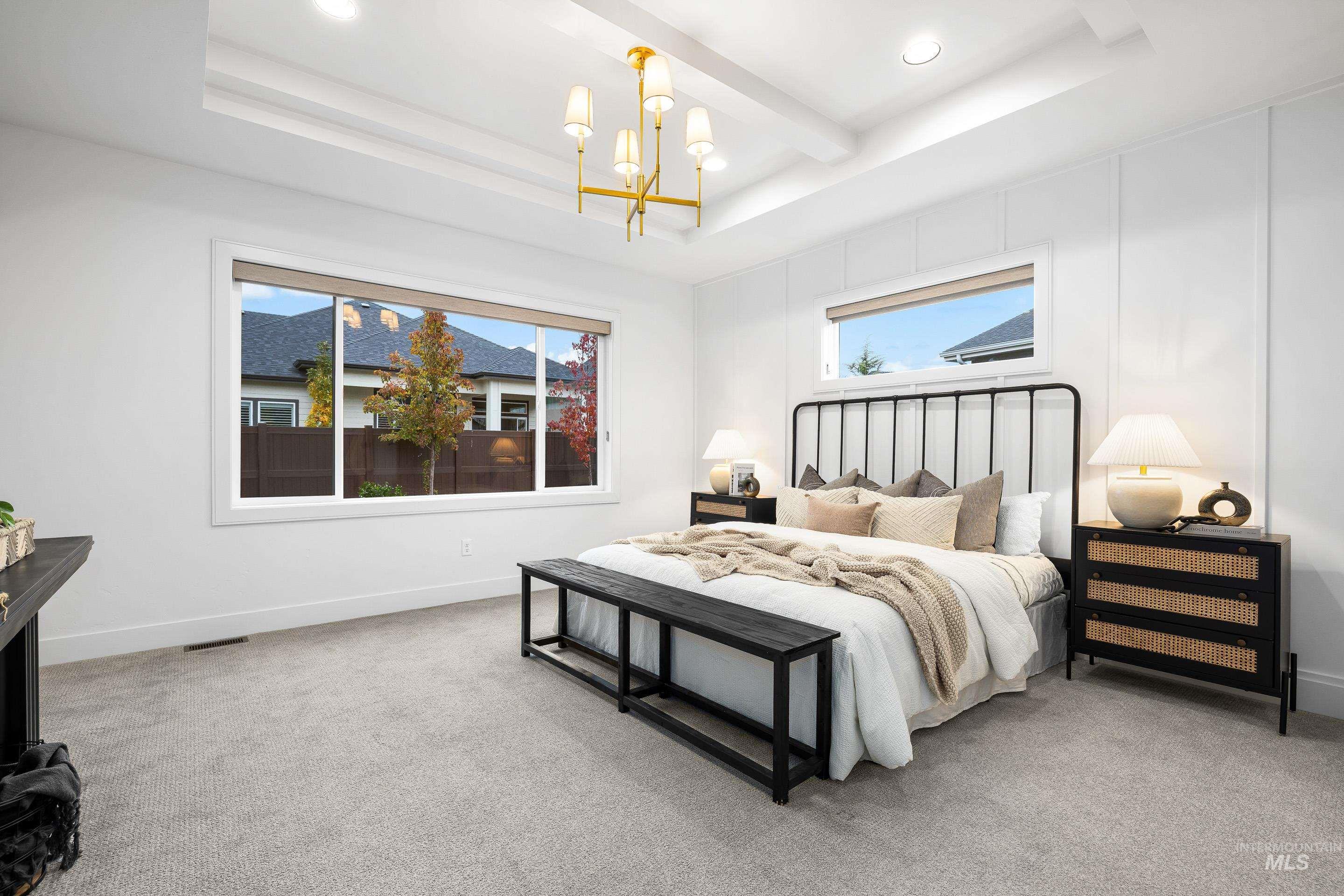 Carpeted bedroom featuring a chandelier, a raised ceiling, beamed ceiling, and recessed lighting