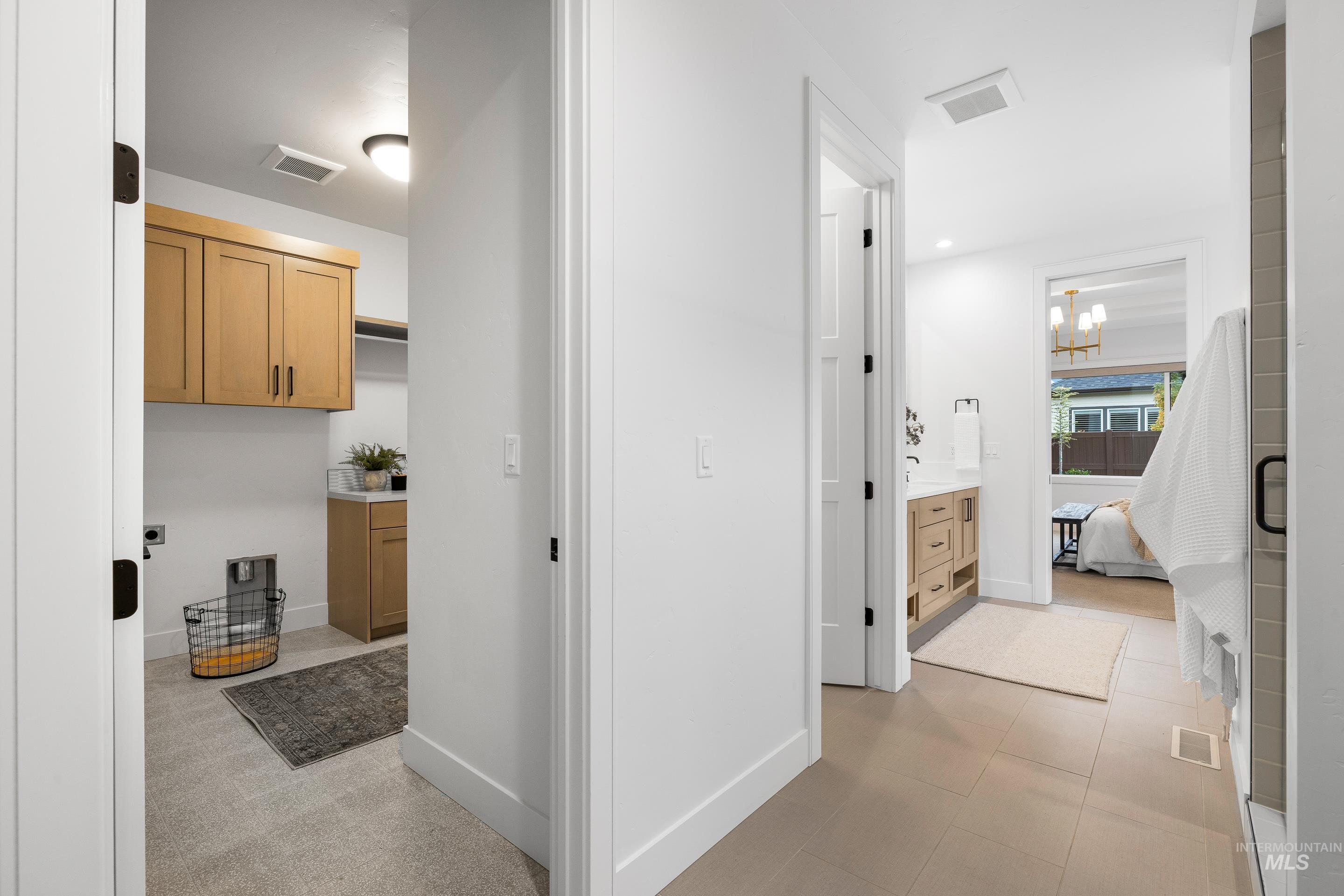Hall featuring a chandelier and light tile patterned floors