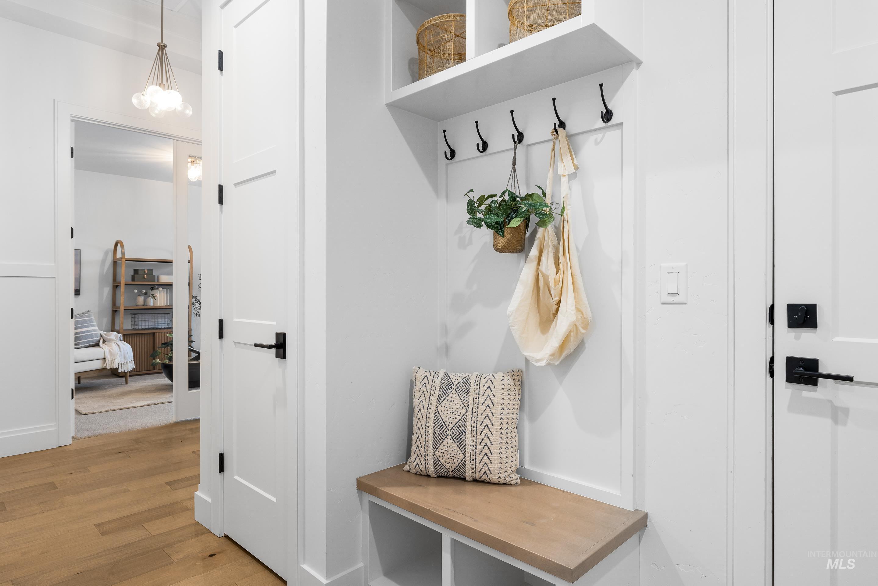 Mudroom with light wood-style flooring and baseboards