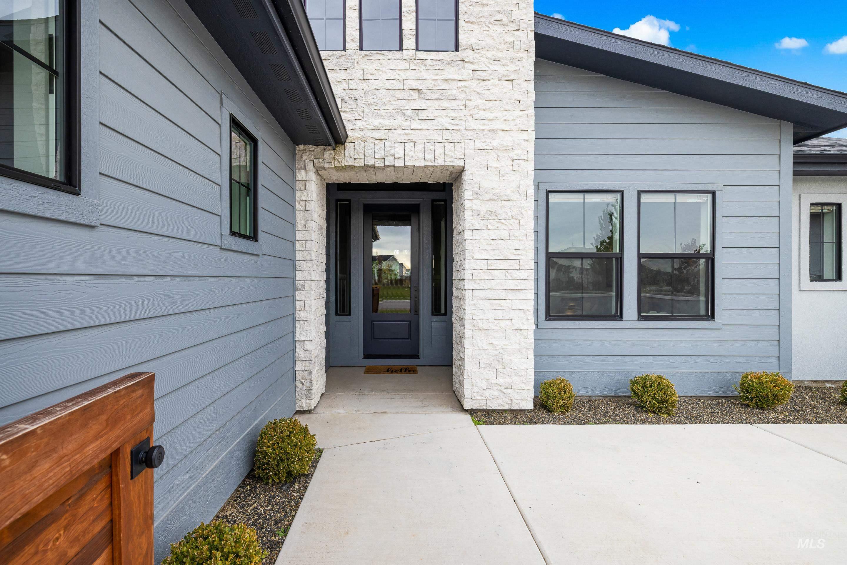Property entrance featuring stone siding