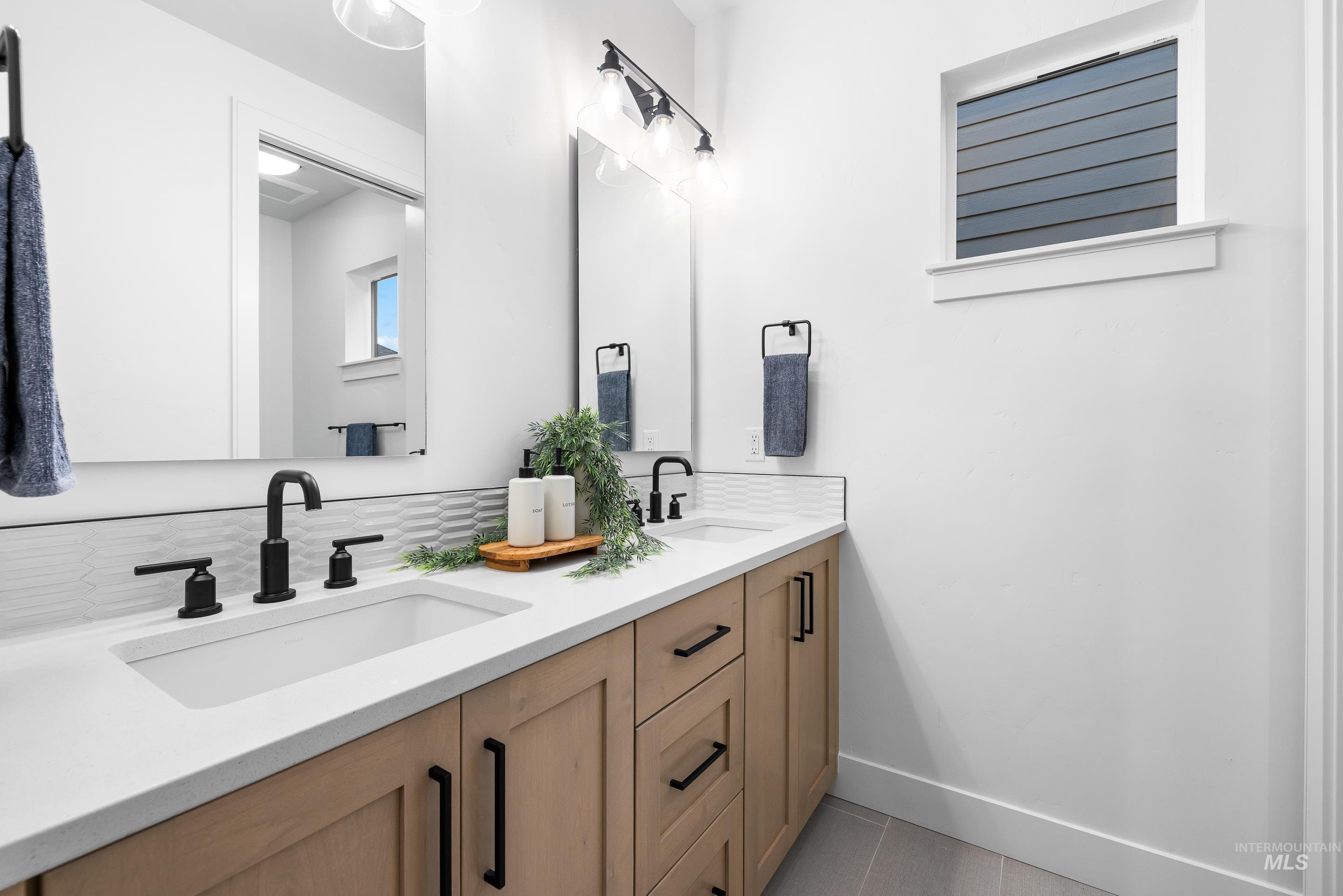 Bathroom featuring double vanity and tile patterned flooring