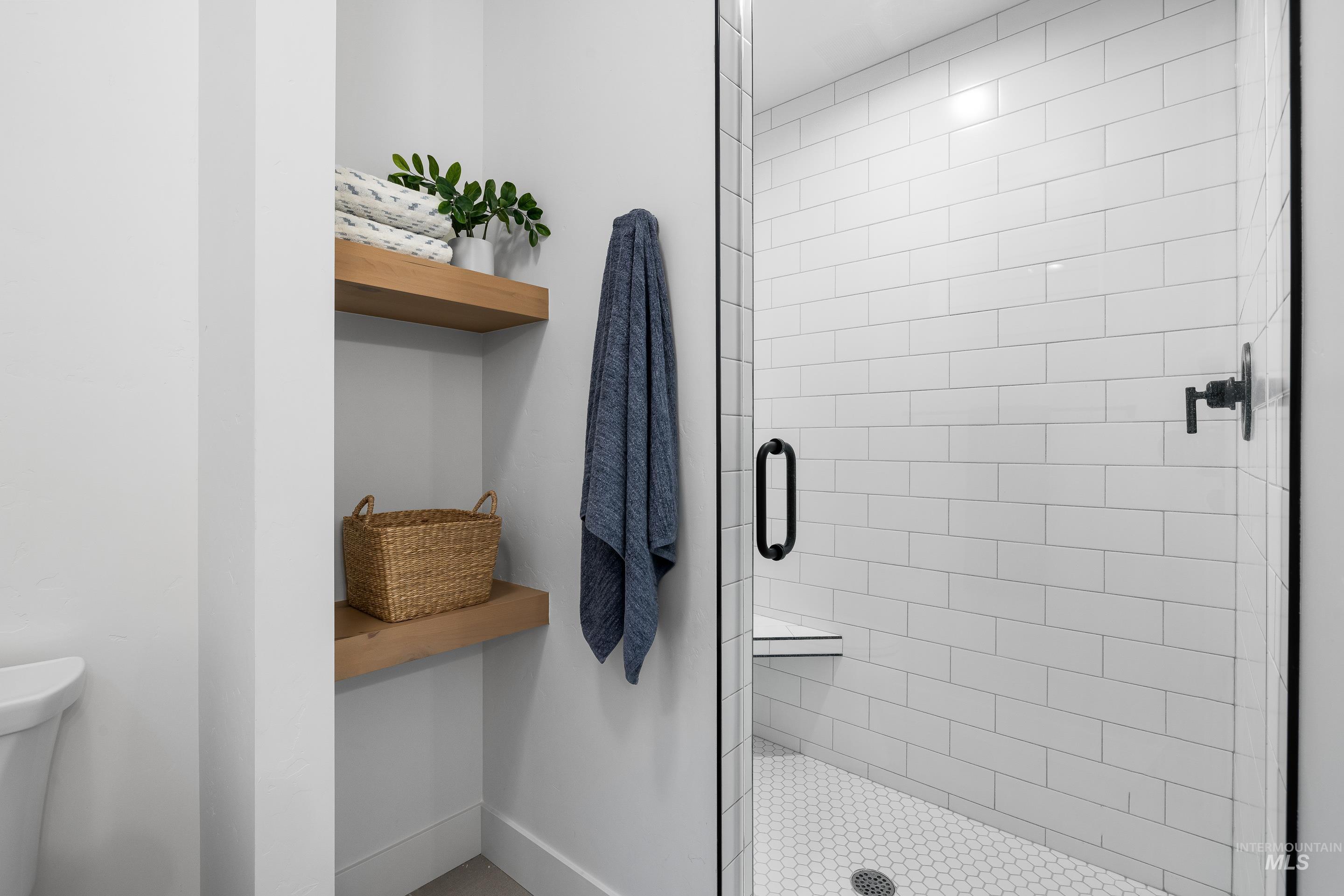 Bathroom featuring a shower stall and toilet