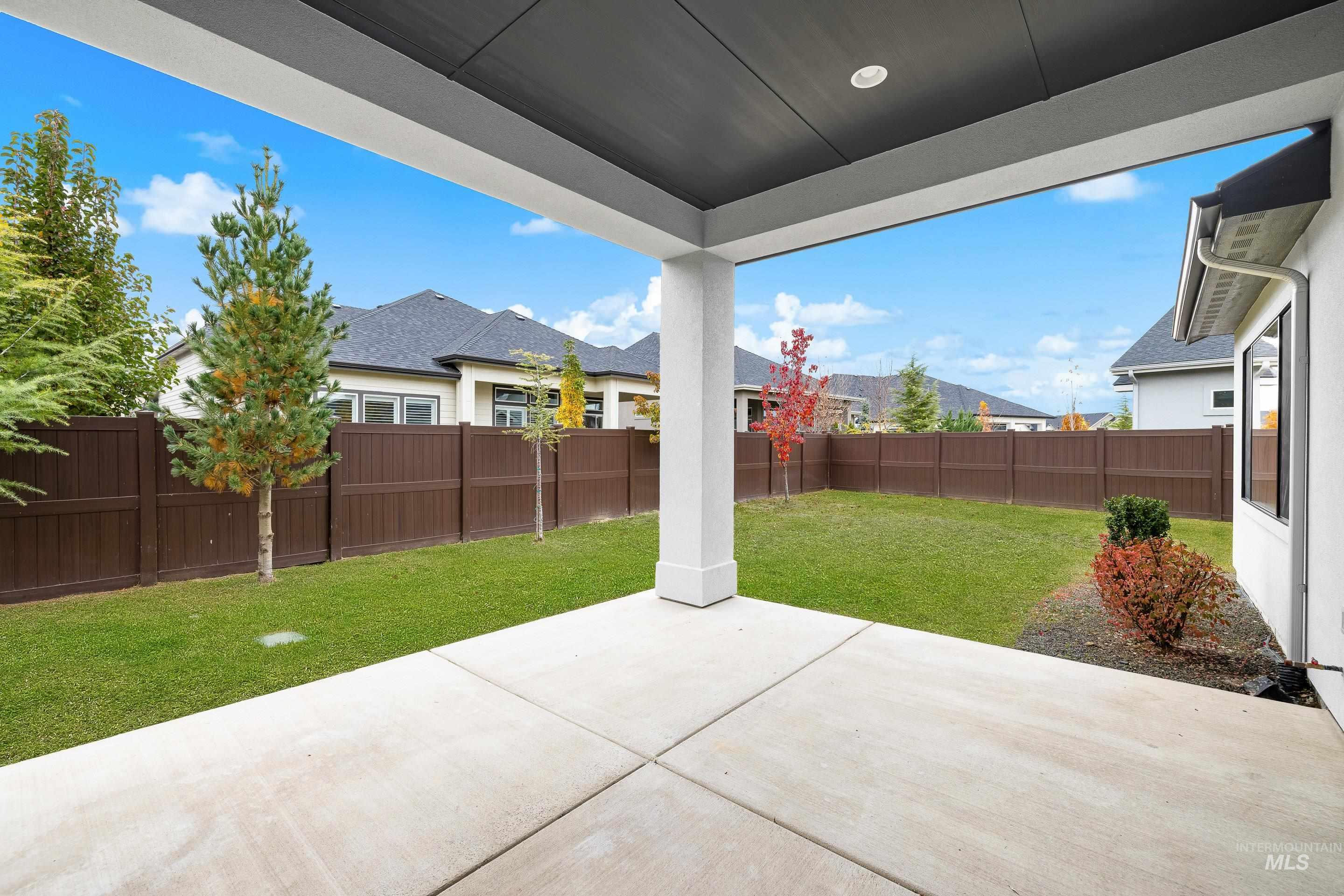 Fenced backyard featuring a patio