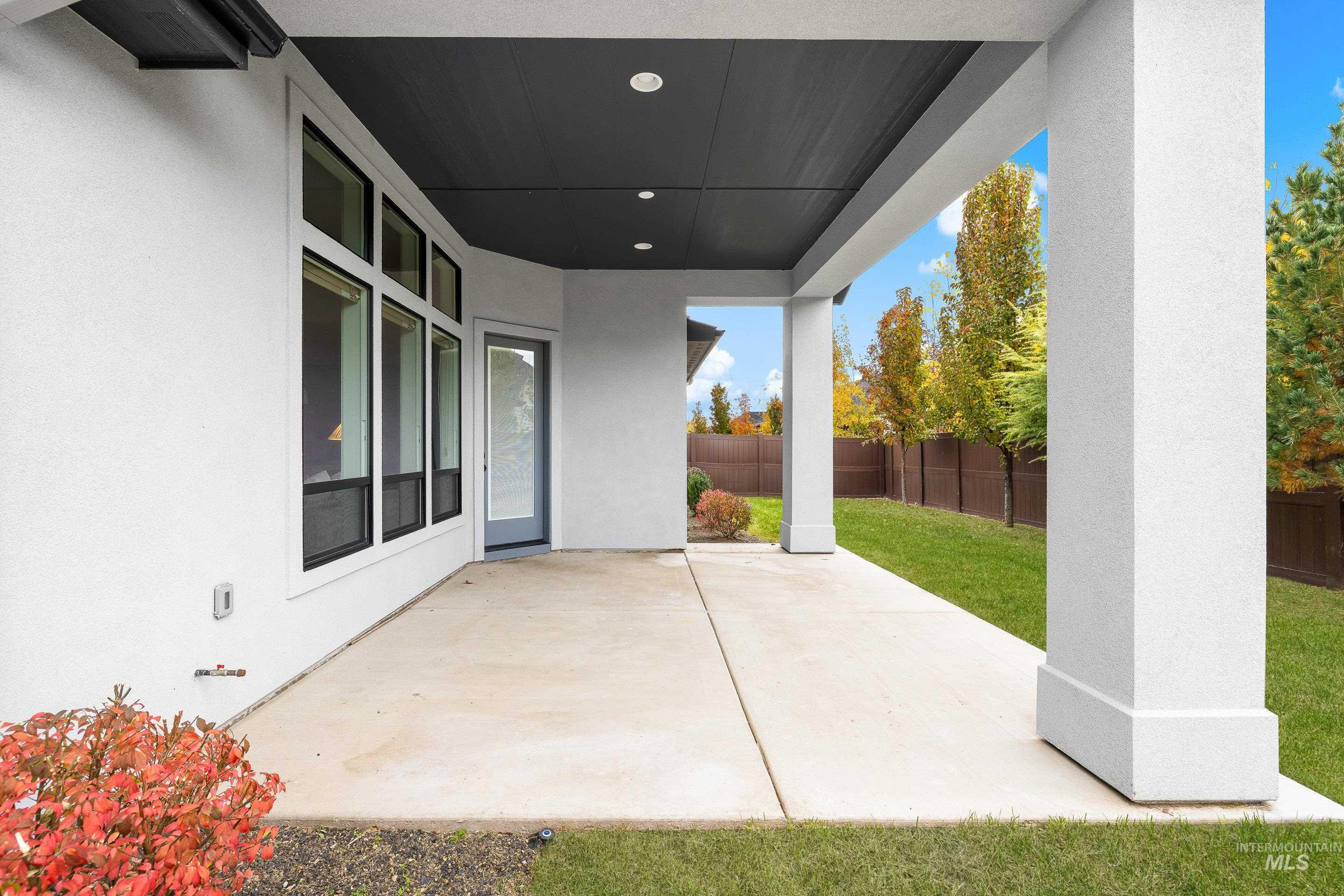 Fenced backyard with a patio area