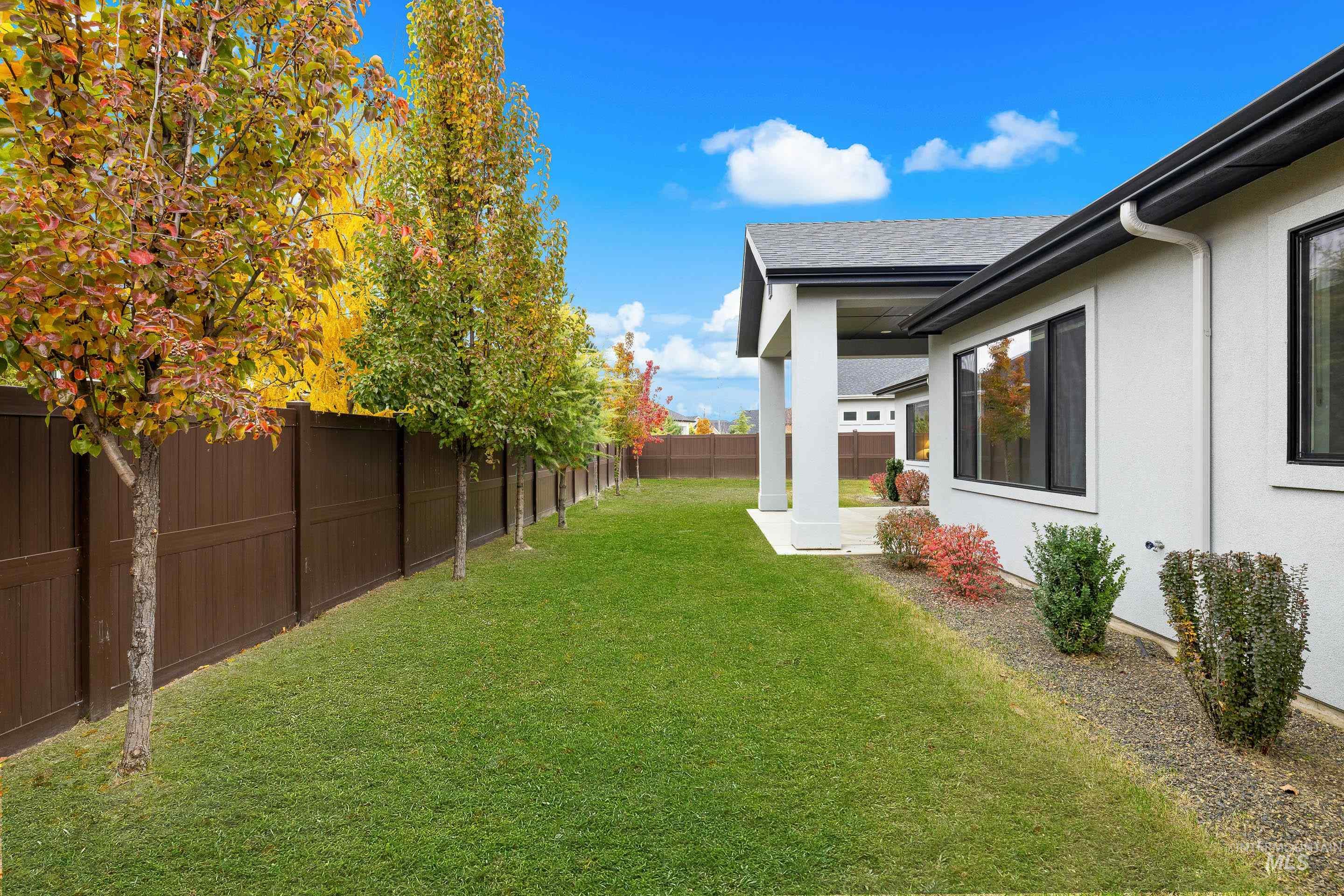Fenced backyard featuring a patio