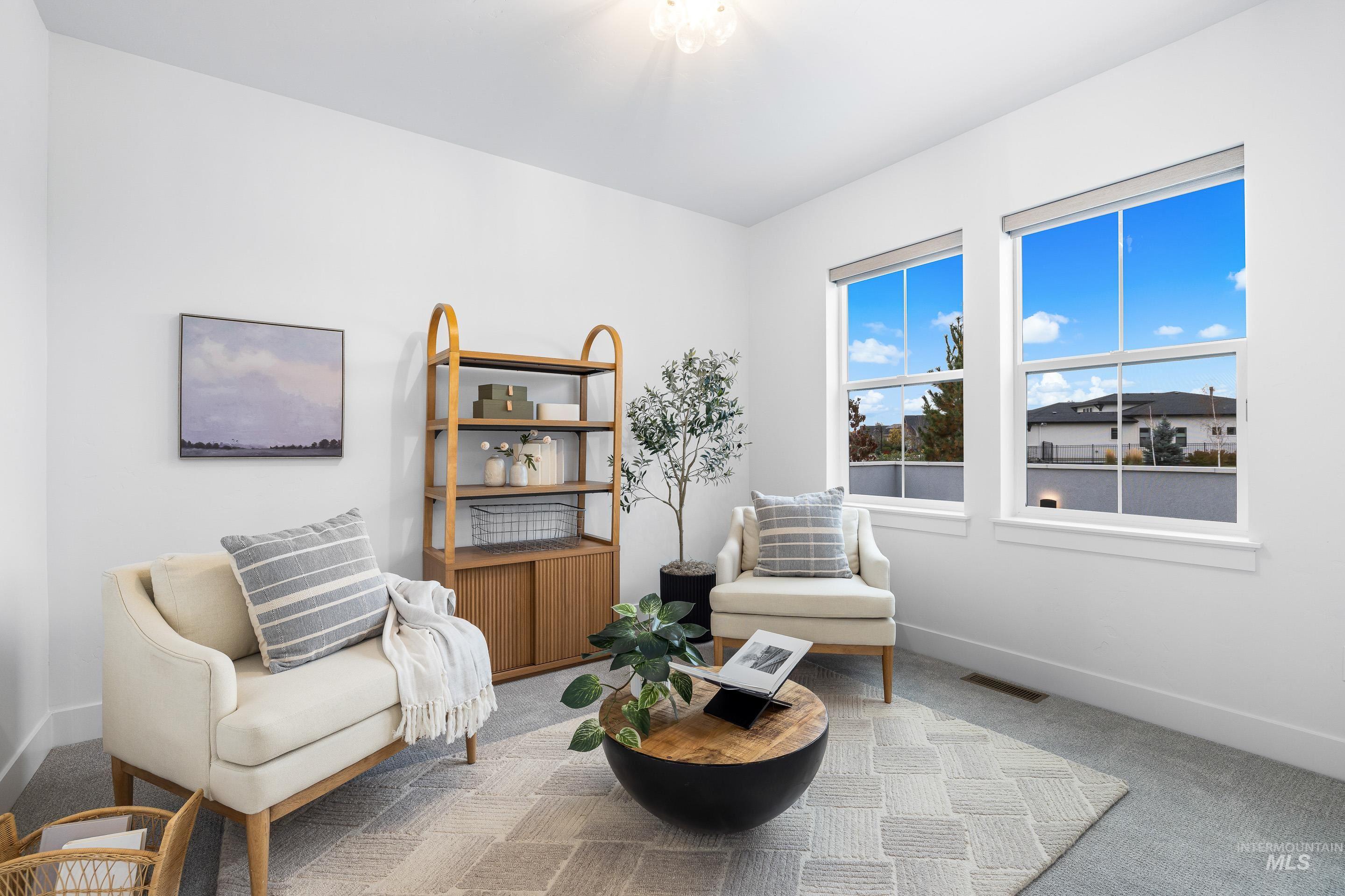 Sitting room featuring carpet and baseboards