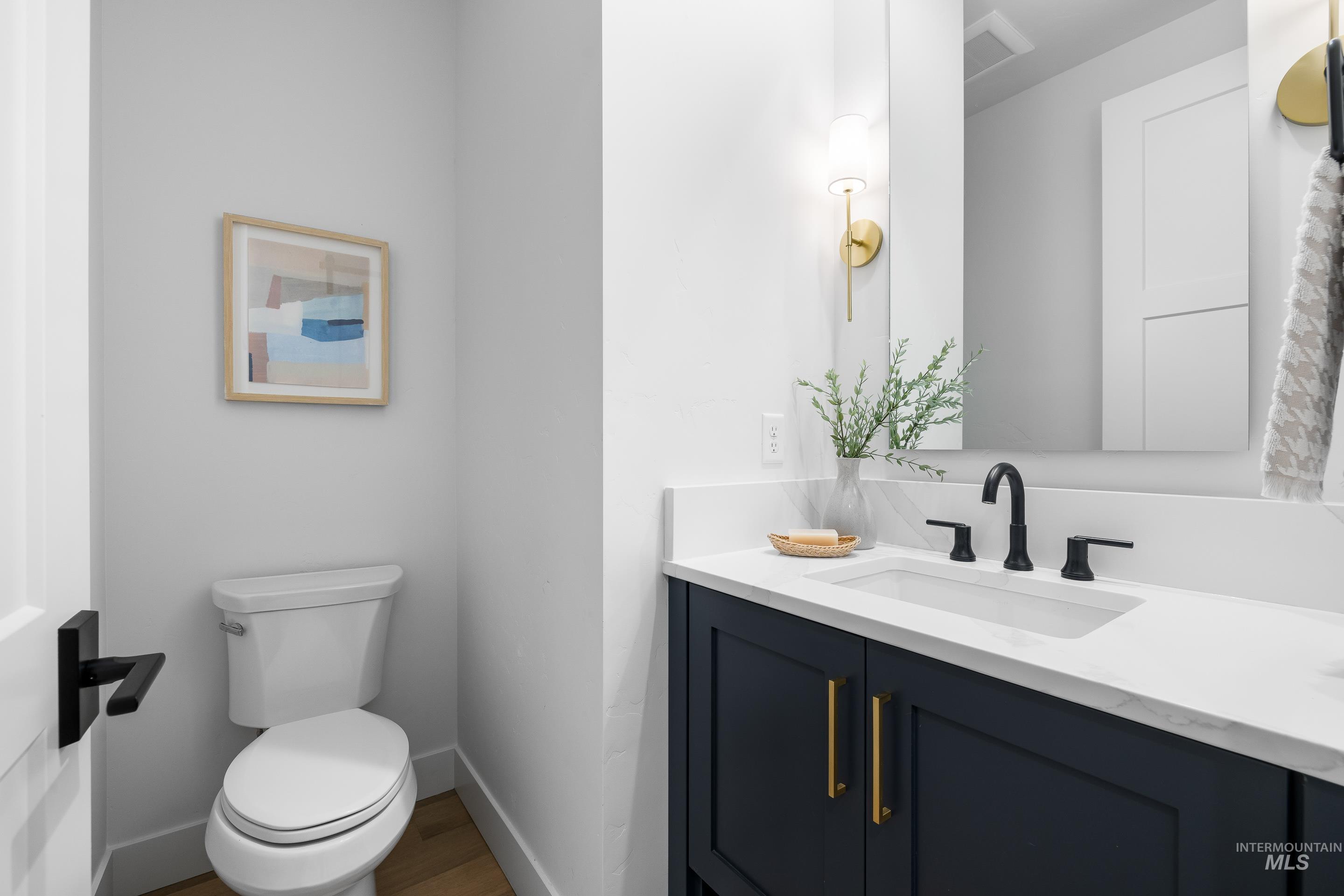 Bathroom featuring vanity and wood finished floors