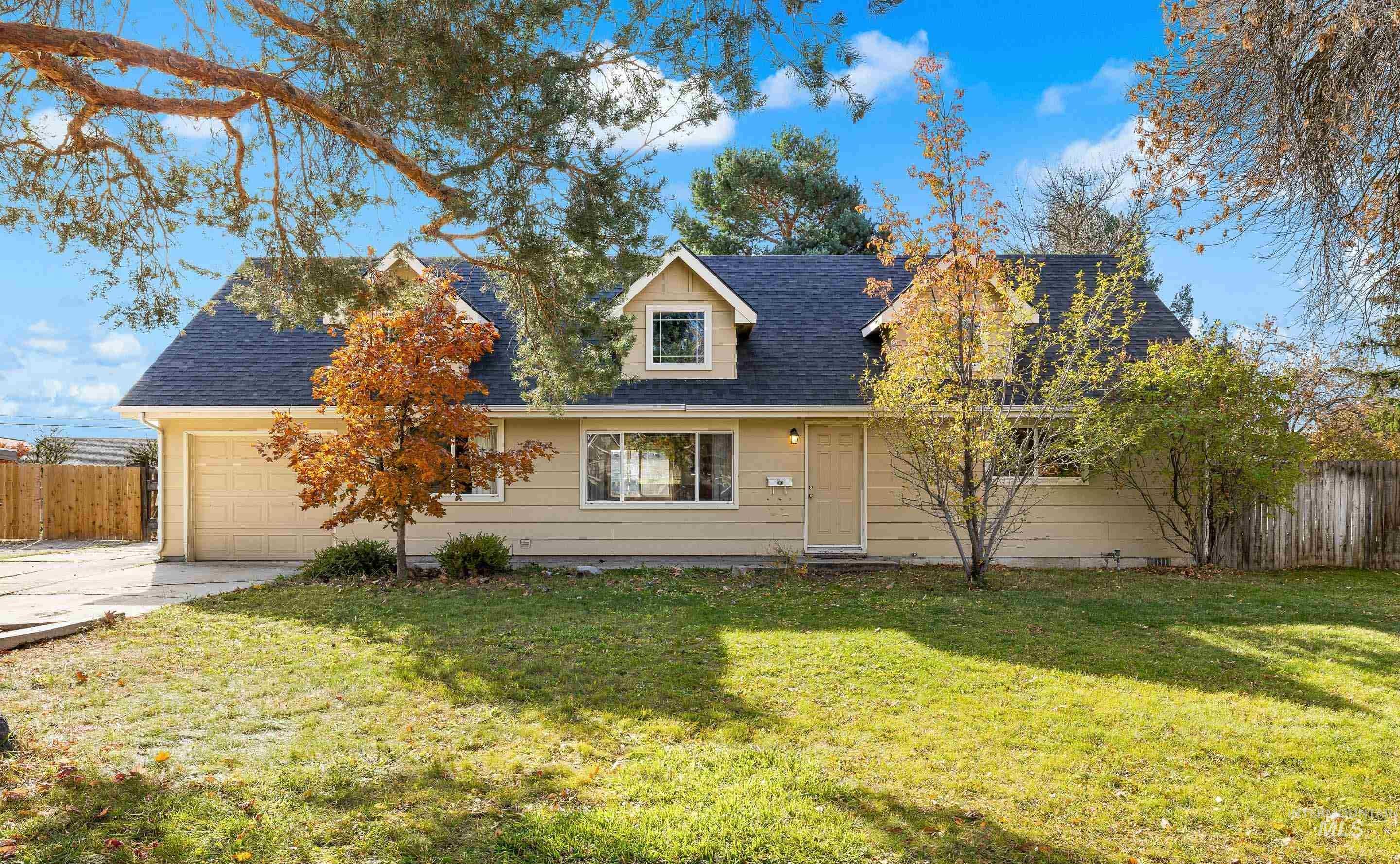 Cape cod house featuring roof with shingles, concrete driveway, and an attached garage
