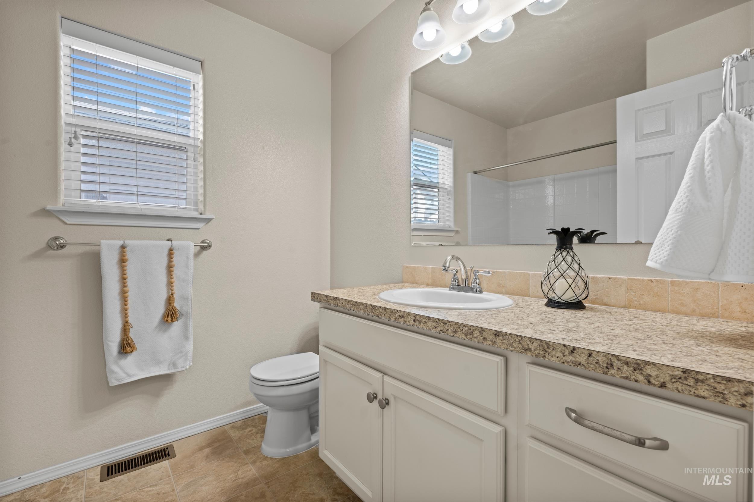 Full bath with vanity and a shower