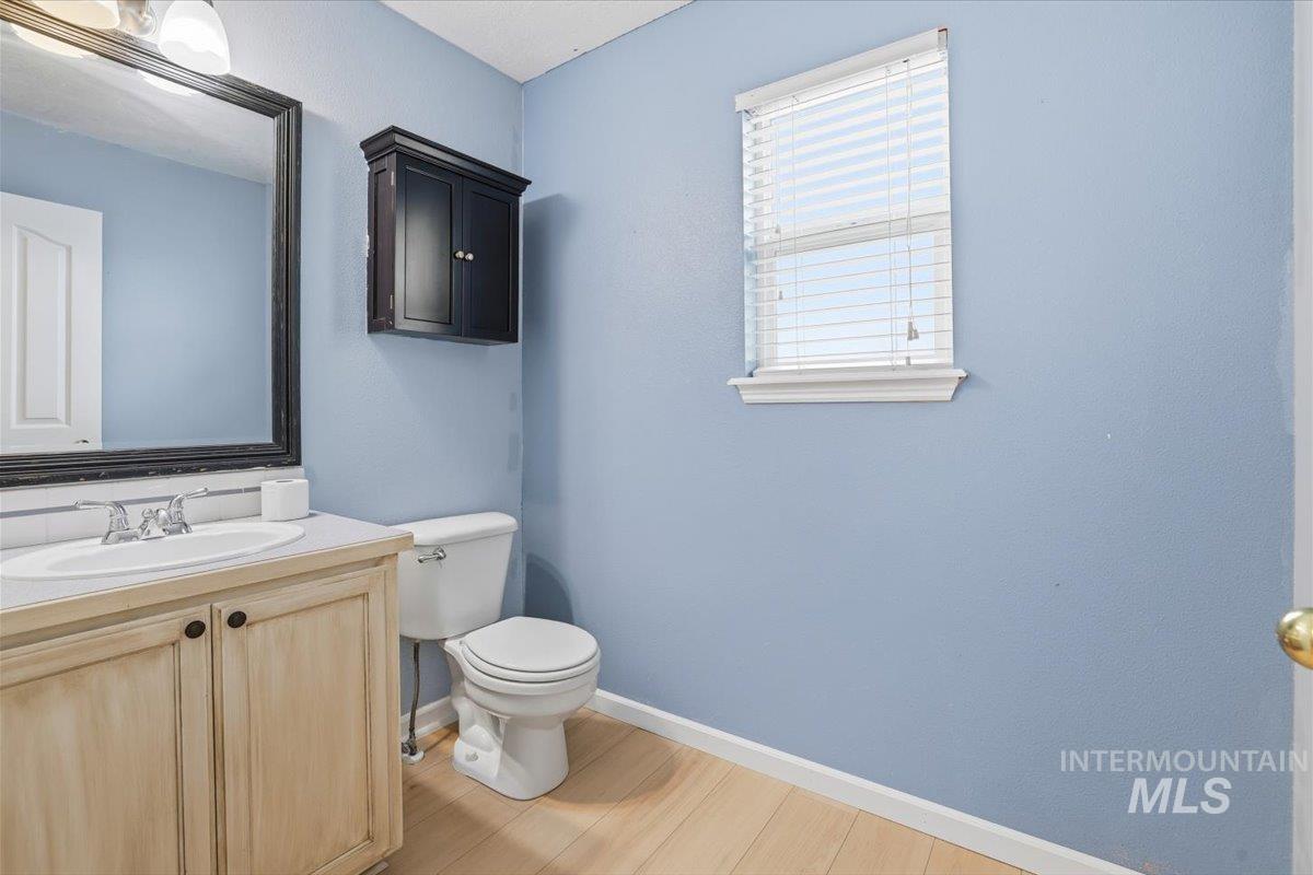 Half bath featuring vanity and light wood-style flooring