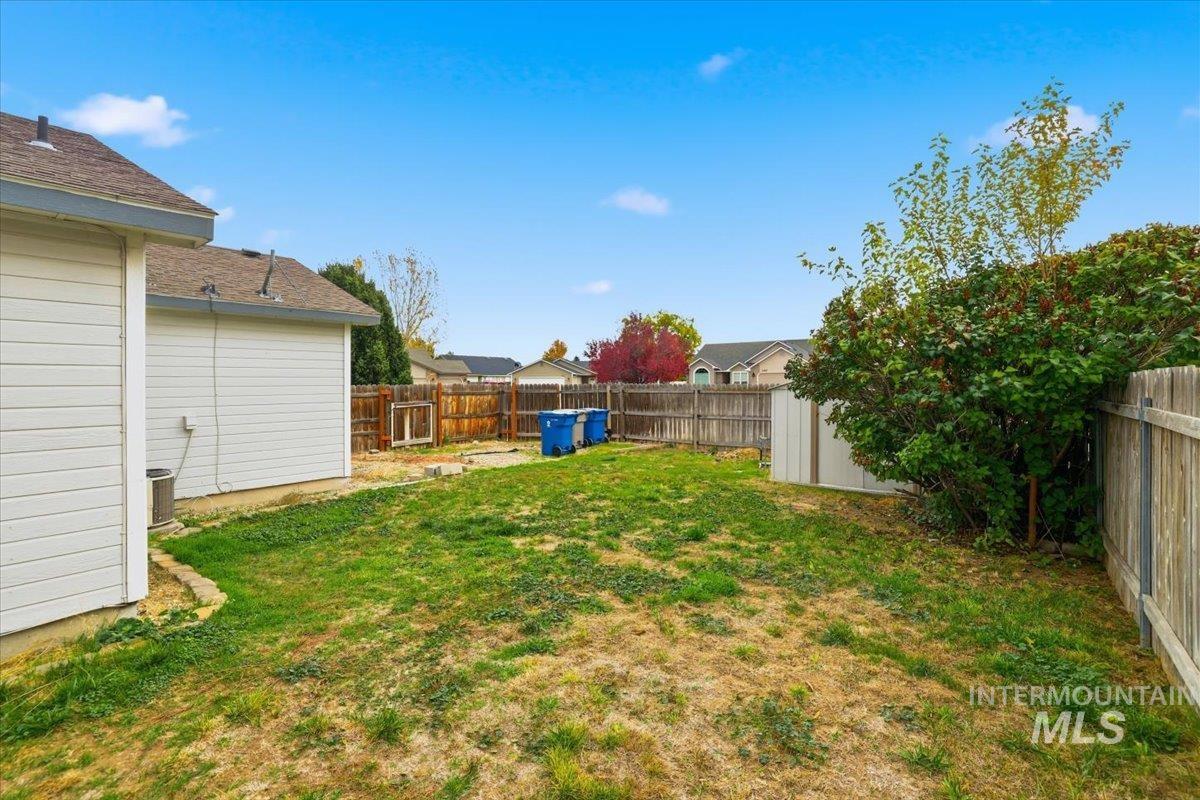 Fenced backyard featuring a residential view