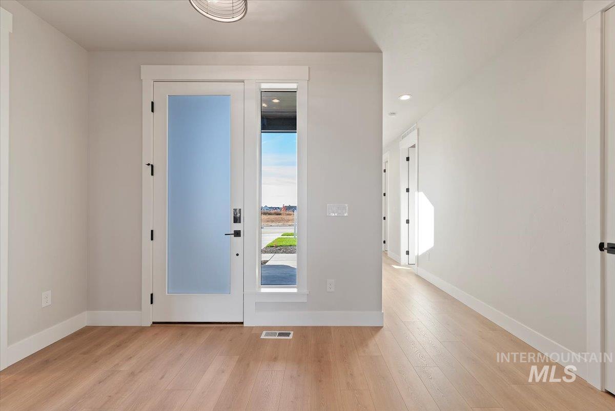 Entryway featuring wood-type flooring and recessed lighting