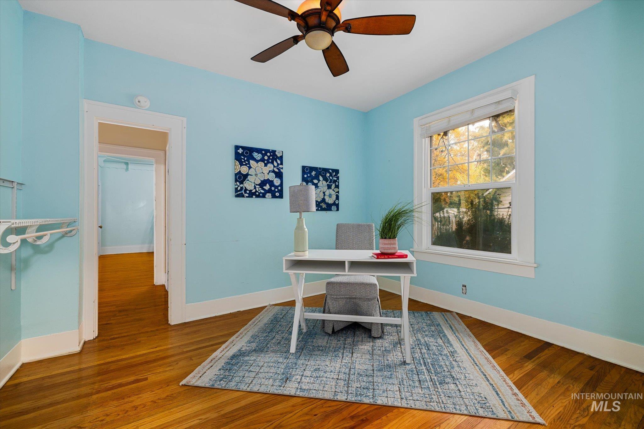 Home office featuring wood finished floors and ceiling fan