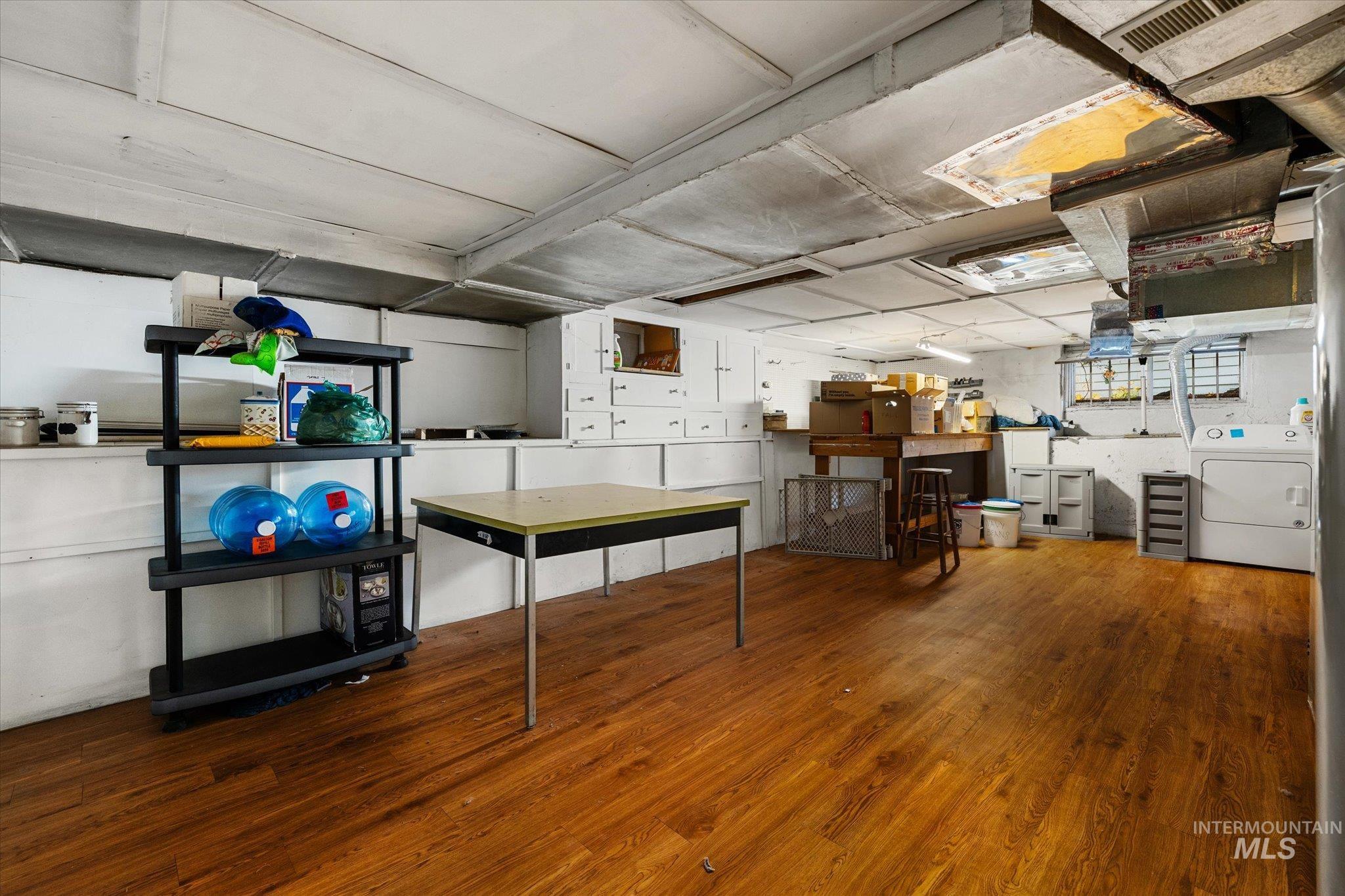 Finished basement featuring wood finished floors and washing machine and dryer