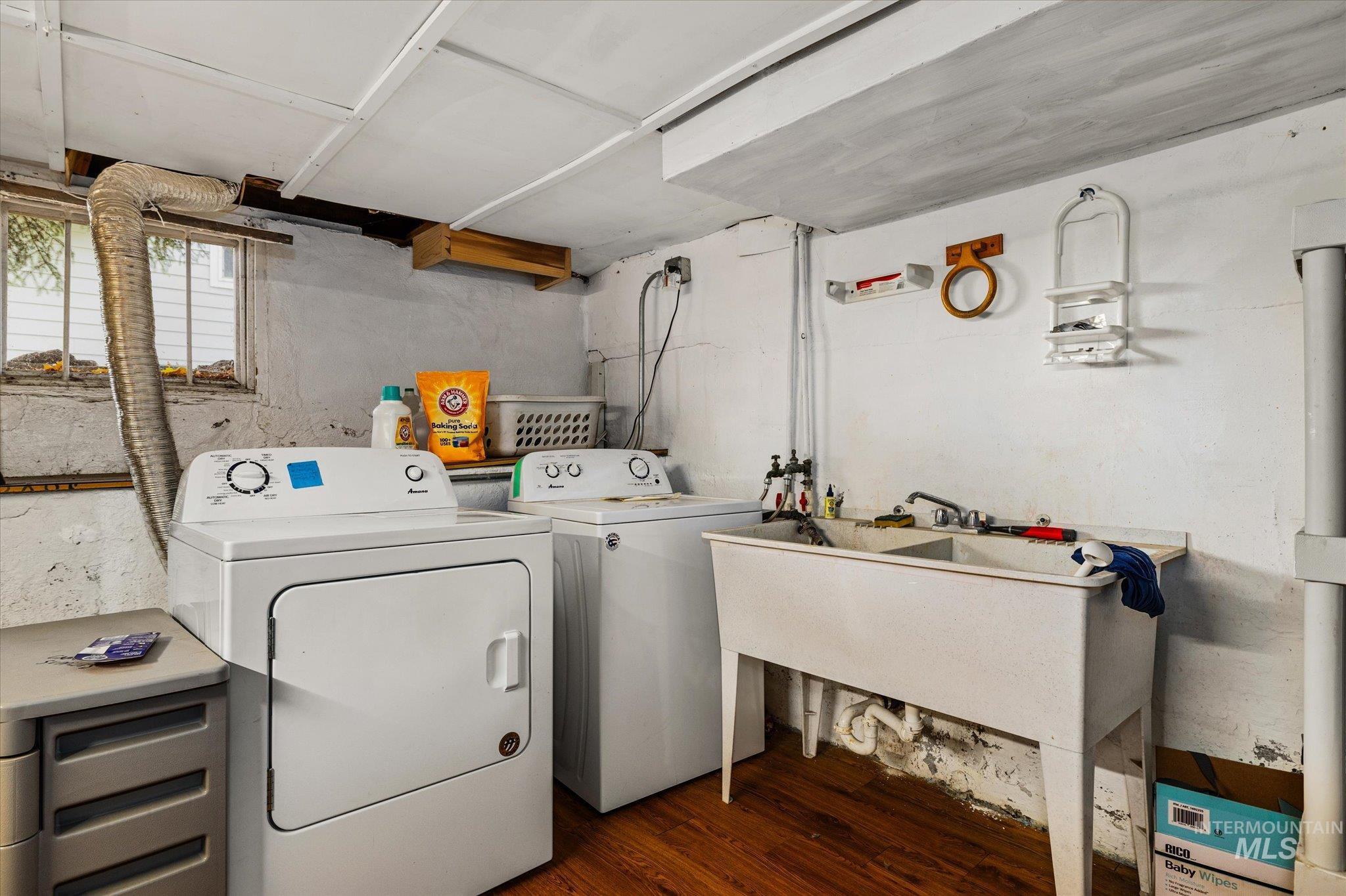 Washroom featuring dark wood-style floors and washer and clothes dryer