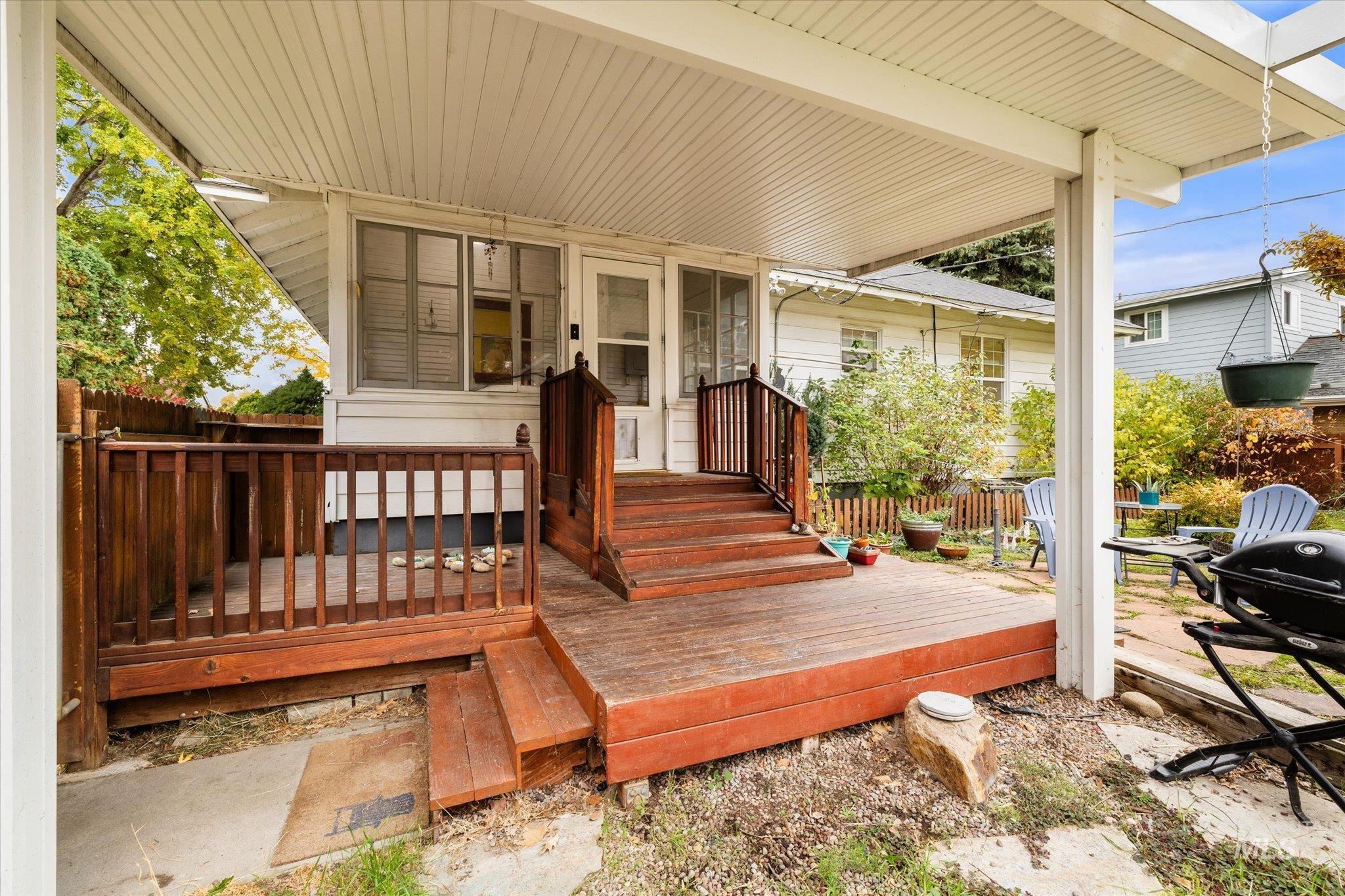 Wooden deck featuring a grill