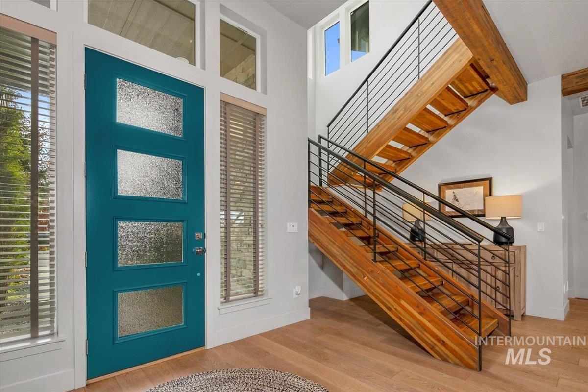 Foyer featuring wood finished floors and a towering ceiling