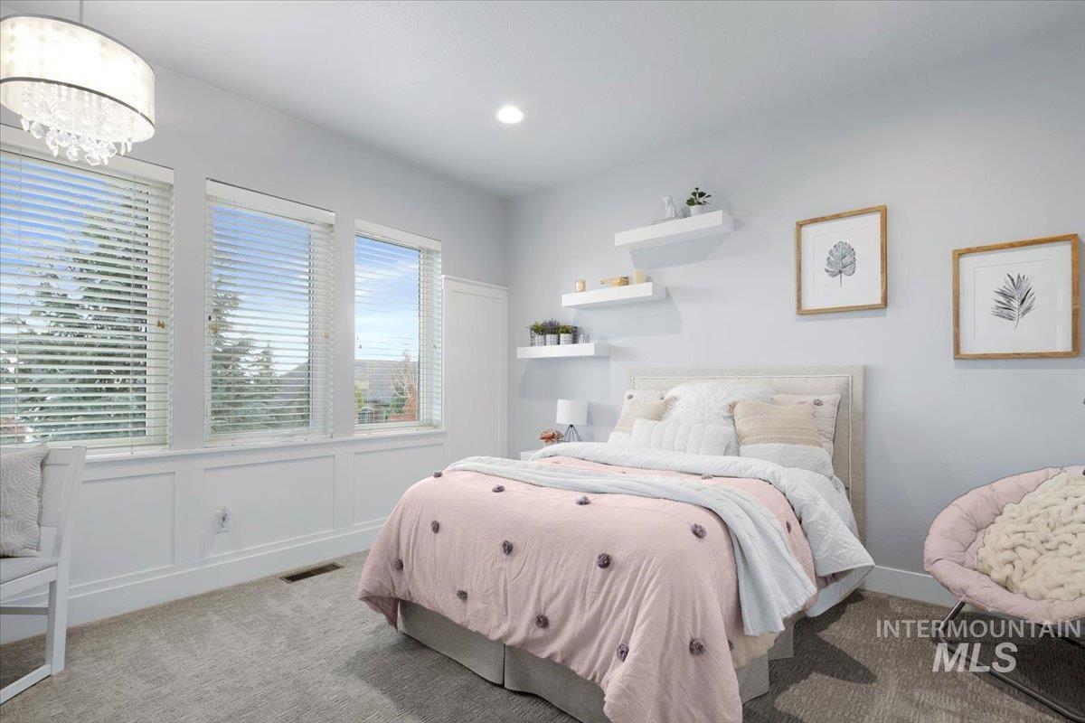 Carpeted bedroom with recessed lighting