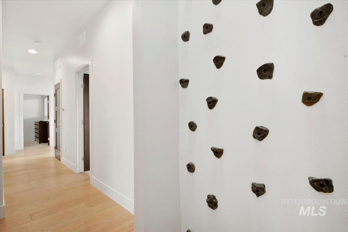 Hallway featuring light wood-style flooring and recessed lighting