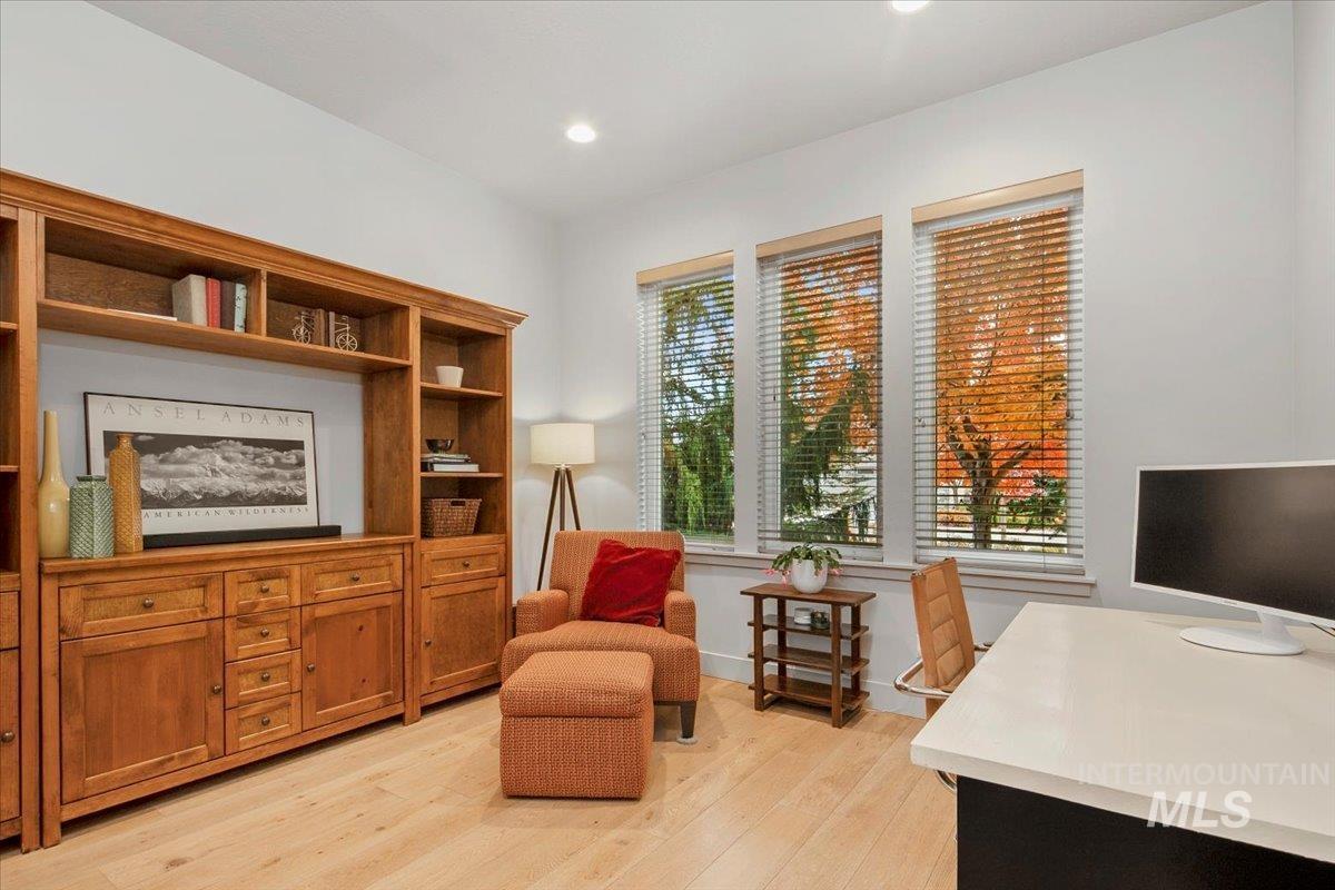 Office space featuring light wood-style floors and recessed lighting