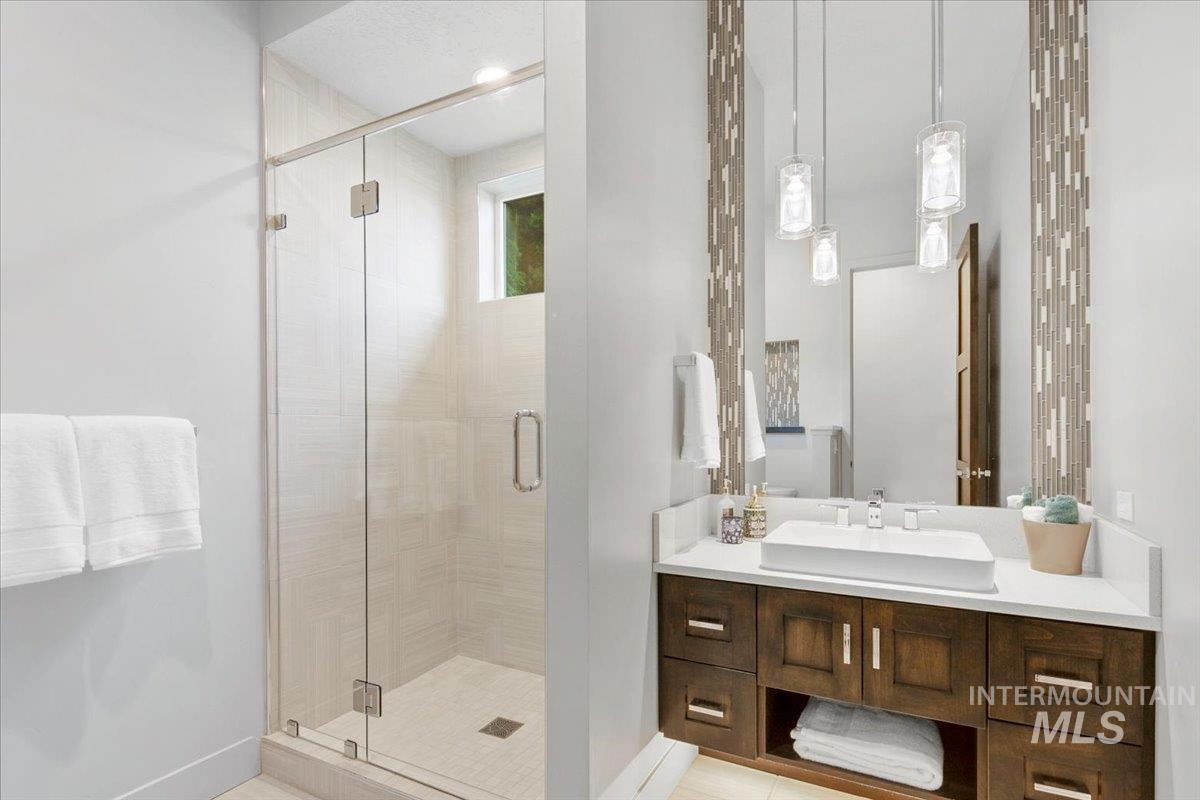 Bathroom with vanity and a stall shower