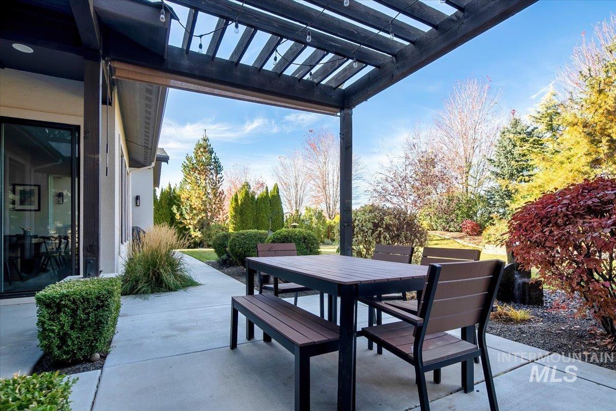 View of patio featuring a pergola and outdoor dining space