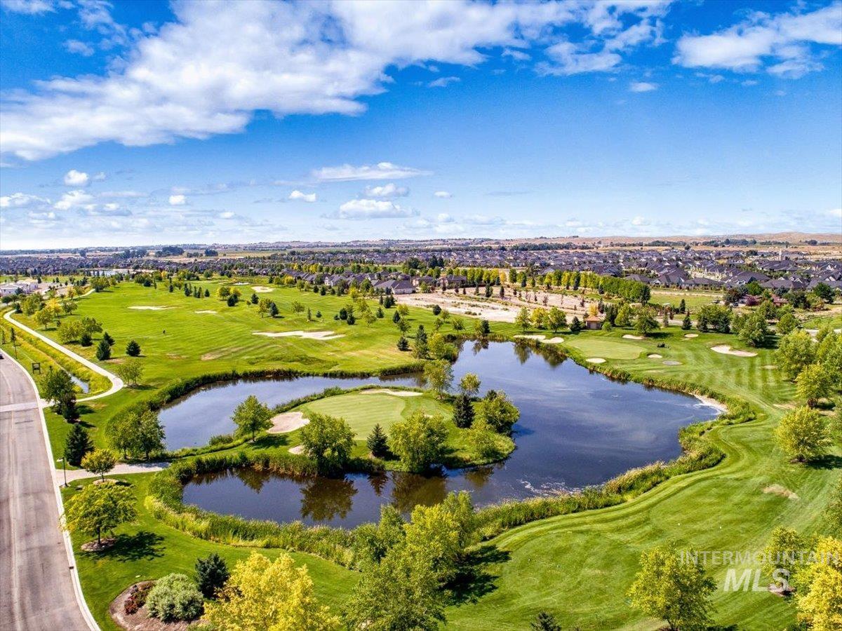 Aerial view of residential area with a large body of water and a local golf course