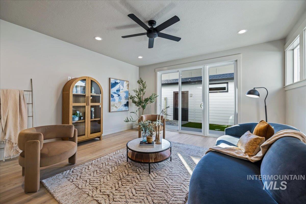 Living area with wood finished floors, recessed lighting, ceiling fan, and a textured ceiling